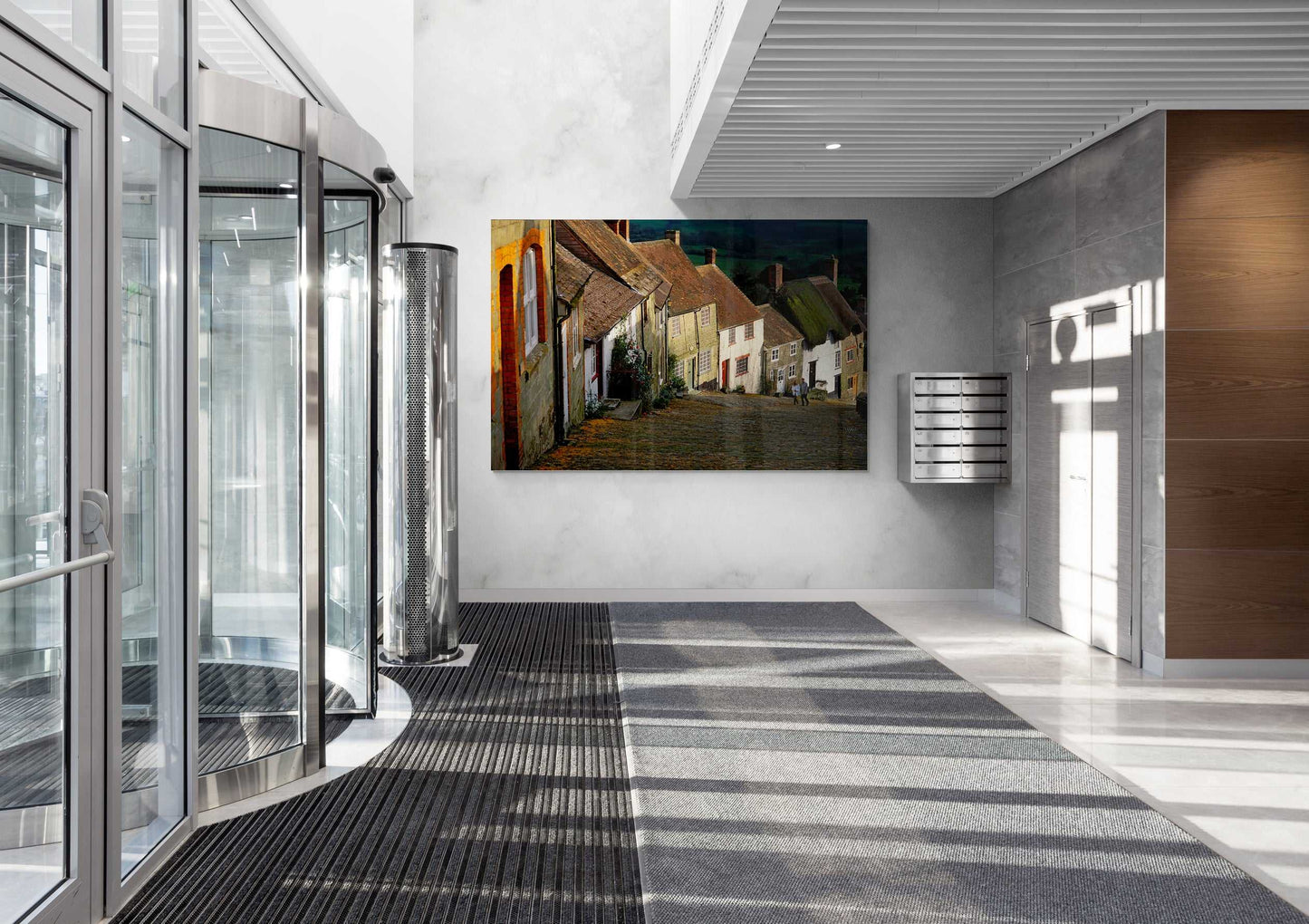 Gold Hill, Shaftesbury – A Fairy Tale Scene in Dorset large canvas print displayed in a contemporary office lobby with glass entrance and modern decor.
