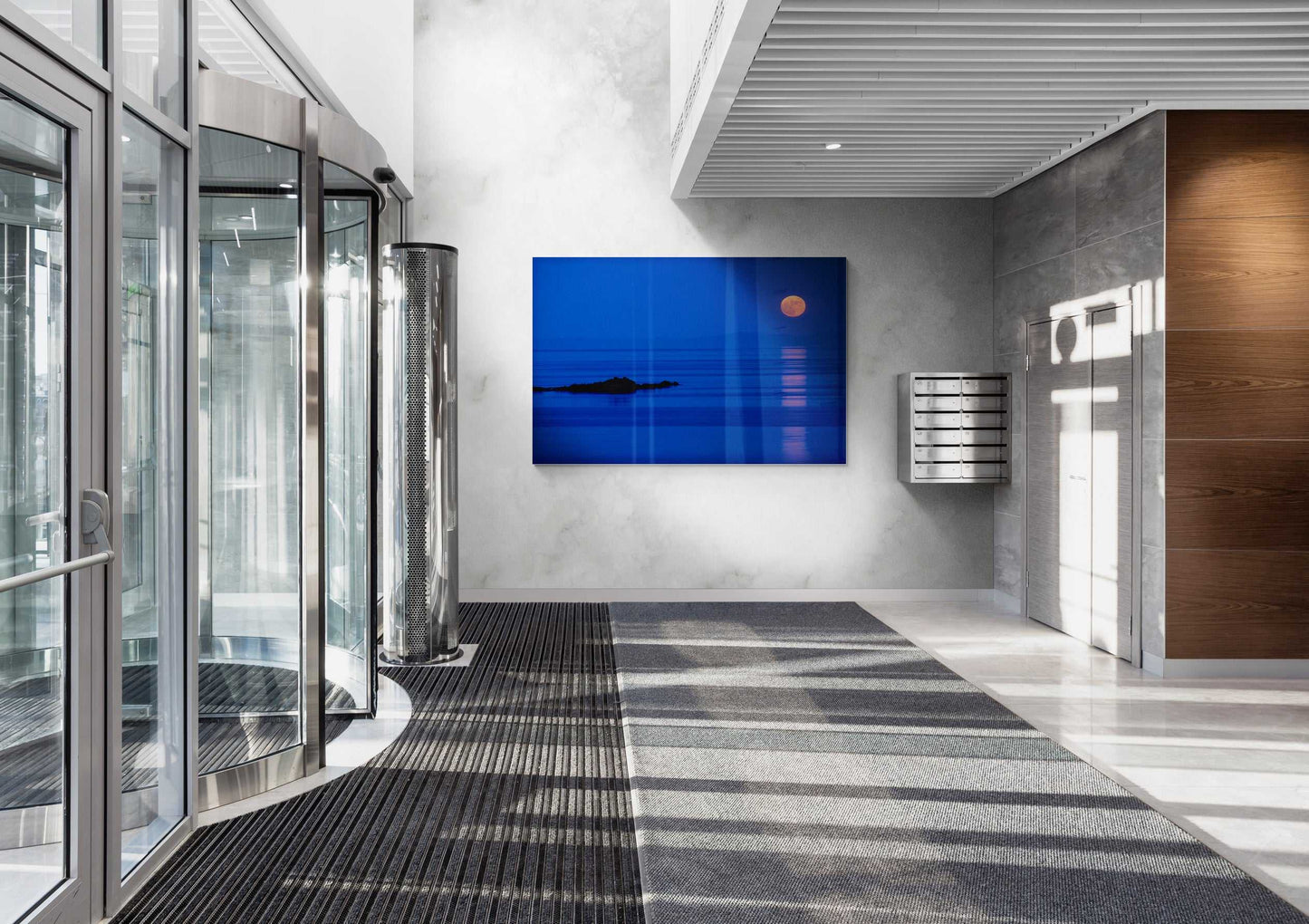Large-format Islay Moonrise over the Atlantic – Fine Art Twilight Photography displayed in a bright lobby, offering a striking coastal Scotland visual centerpiece for modern spaces.