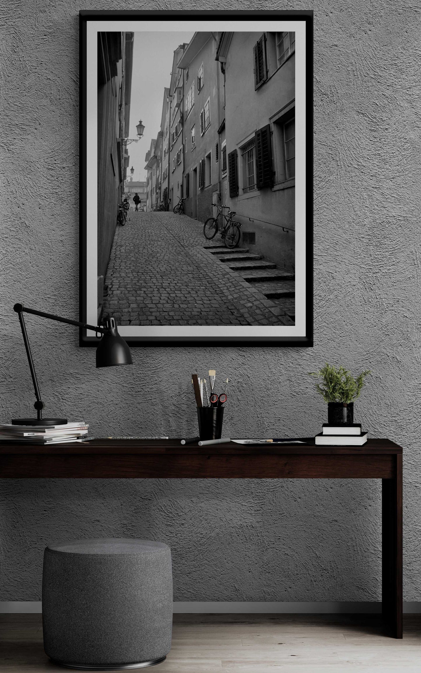 Zurich Series #5 fine art black and white print by Michael Hart displayed above a dark wood desk. European street photography enriches modern workspace design.