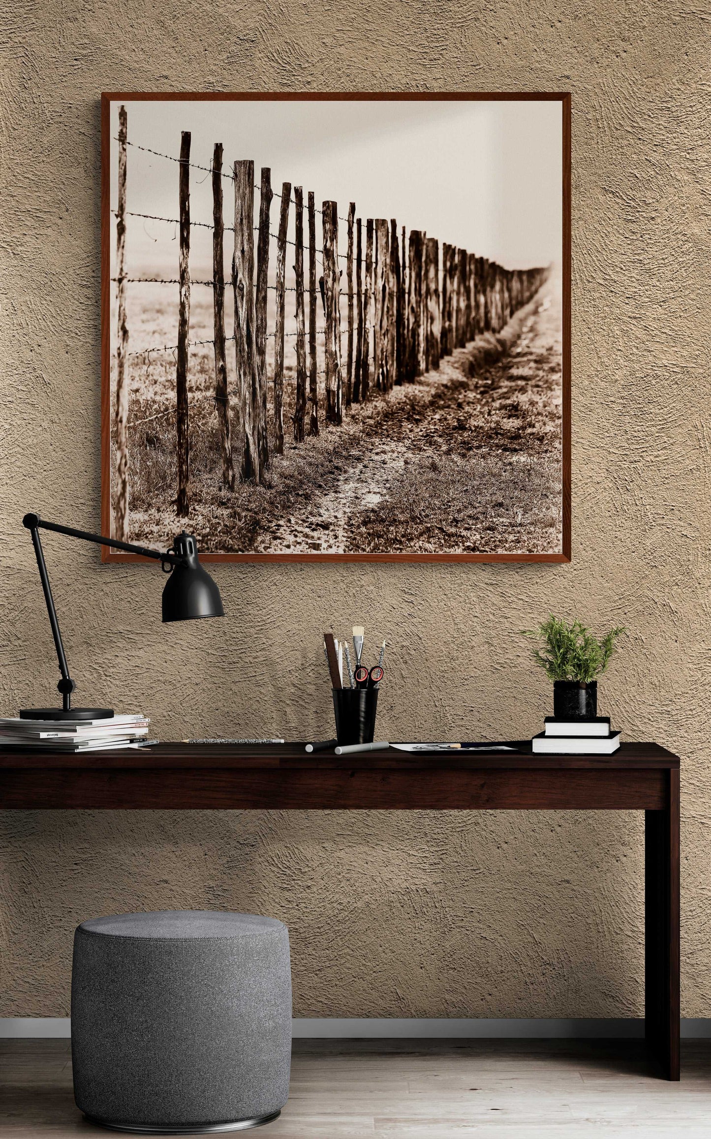 Eight Miles from Nowhere: Fence Line in the Fog, 44 Farms print above a dark wood desk. Enhances home office with historical Texas landscape art.
