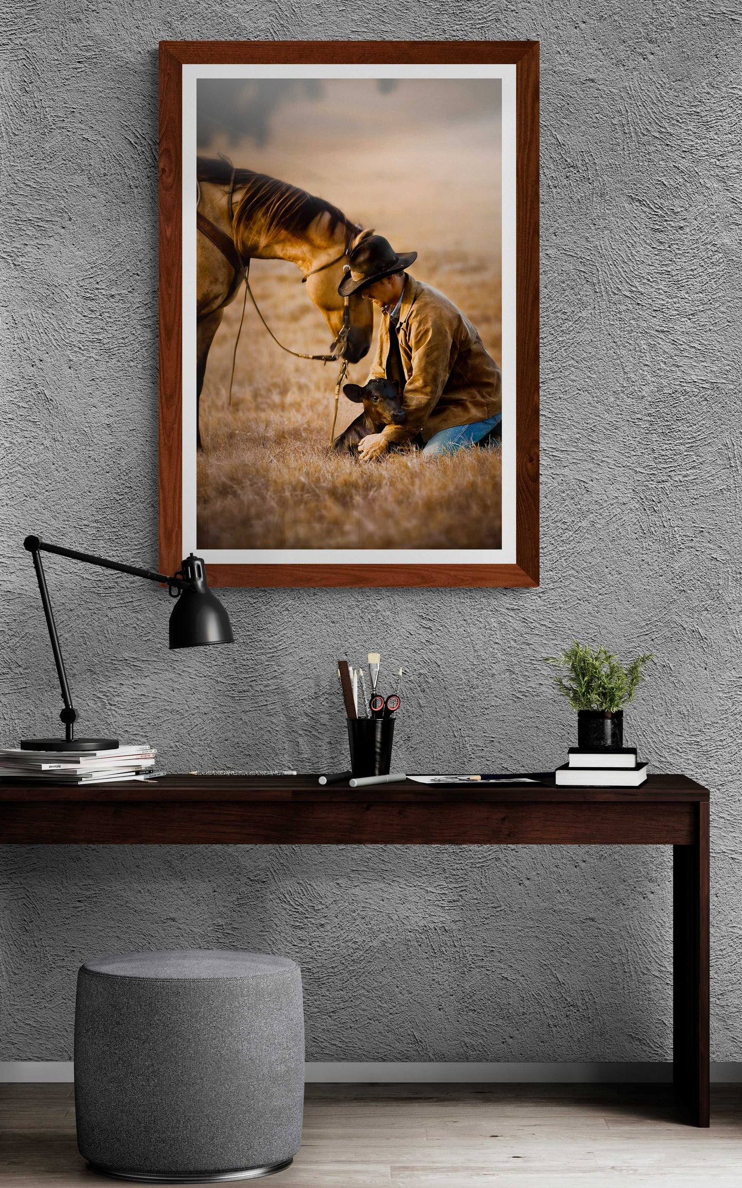 Texas cowboy art print in a wooden frame above a minimalist desk, adding warmth and authenticity to a modern home office space.