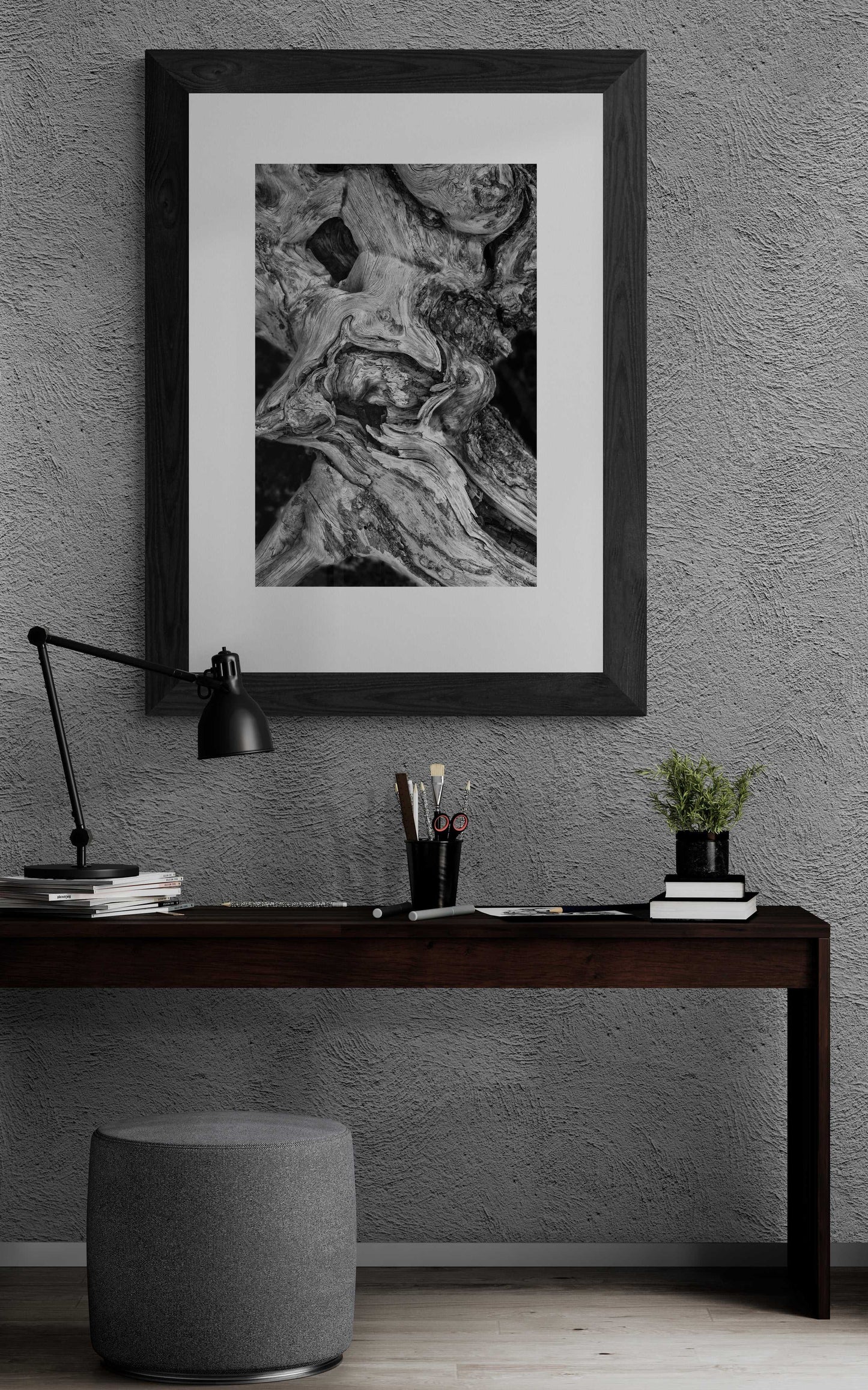 Dead Tree Detail, Yellowstone – Limited Edition Black and White Fine Art Photograph in black frame, featured above a dark wood desk in a contemporary workspace.