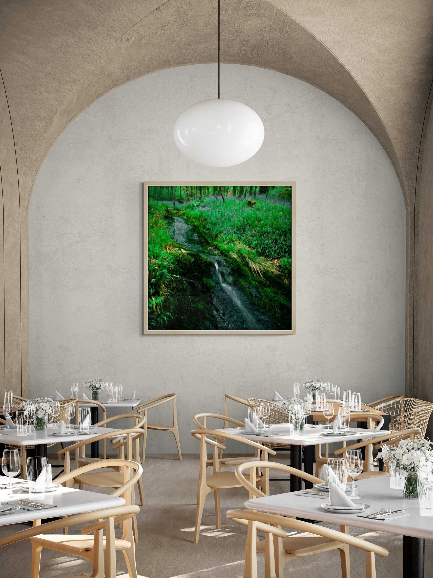 Lomond Creek fine art nature photography displayed in a stylish restaurant, showing a verdant Scottish glen with a flowing creek and blooming bluebells.
