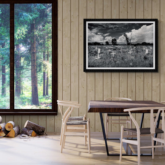 Framed Fort Washakie Cemetery fine art print displayed in rustic dining room, showcasing Native American heritage and dramatic Wyoming landscape.