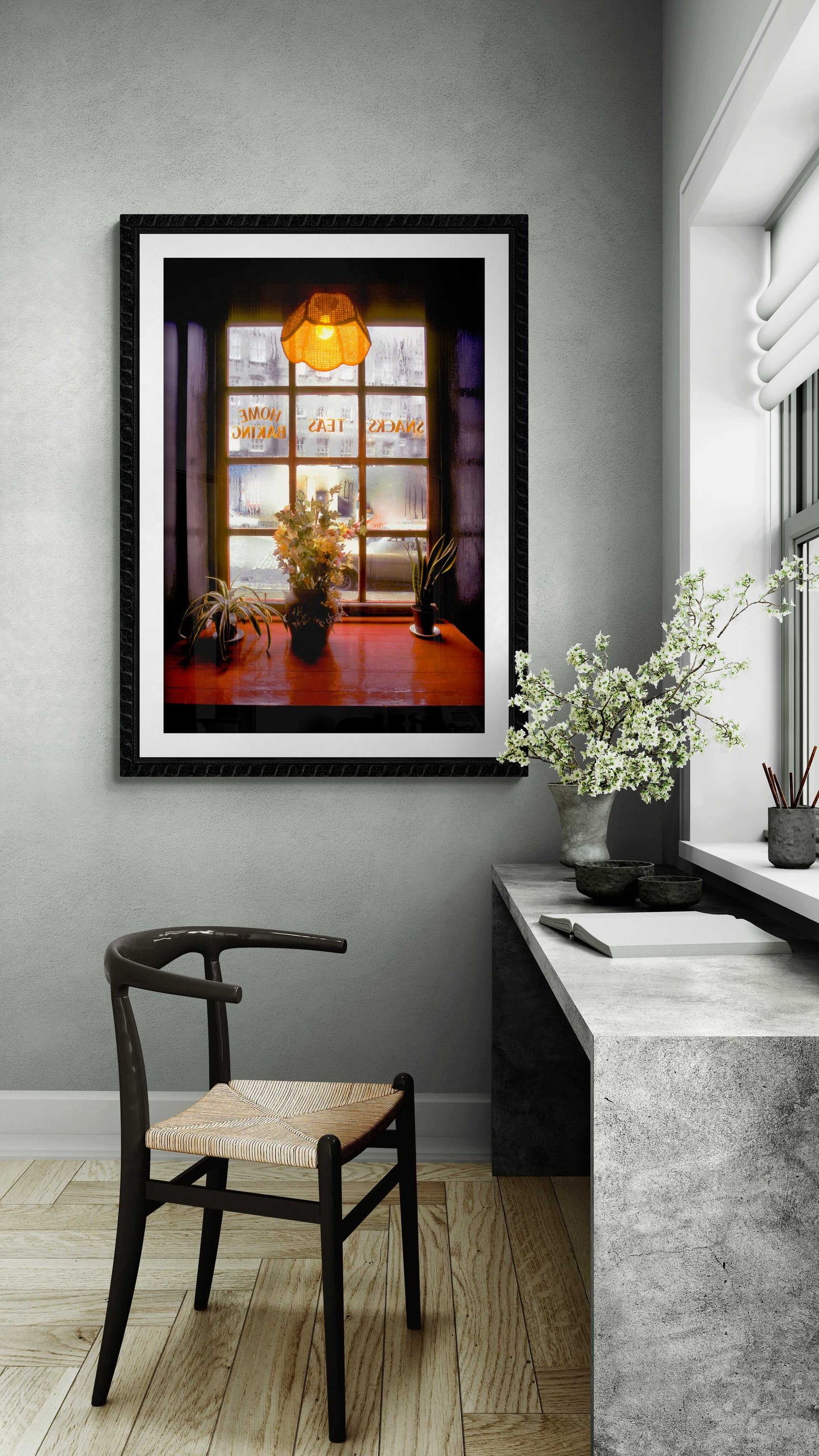 Fine art Scotland print of misty tea shop window with floral still life, elegantly framed in a minimalist home office with natural light.