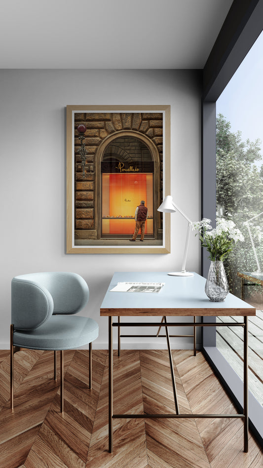 Solitary man window shopping beneath warm evening light on a street in Florence, Italy.