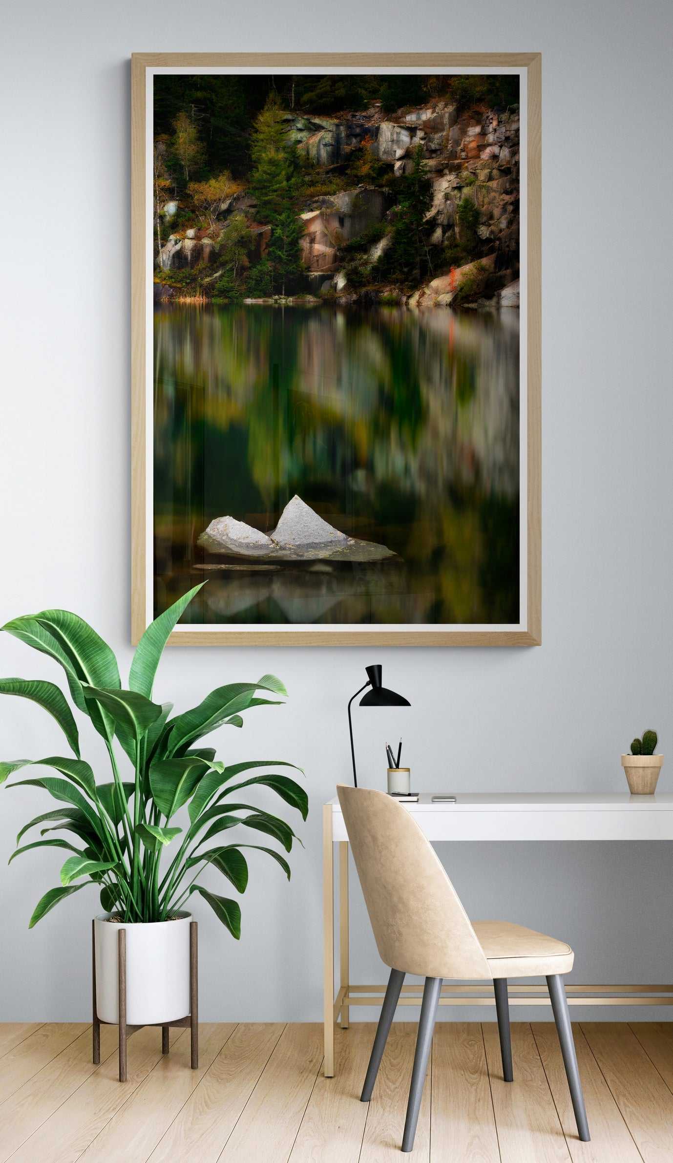 The Sentinel – A Lone Rock Emerges Above The Quarry Waterline, Maine fine art print displayed in a light-toned home office, complementing modern decor and greenery.