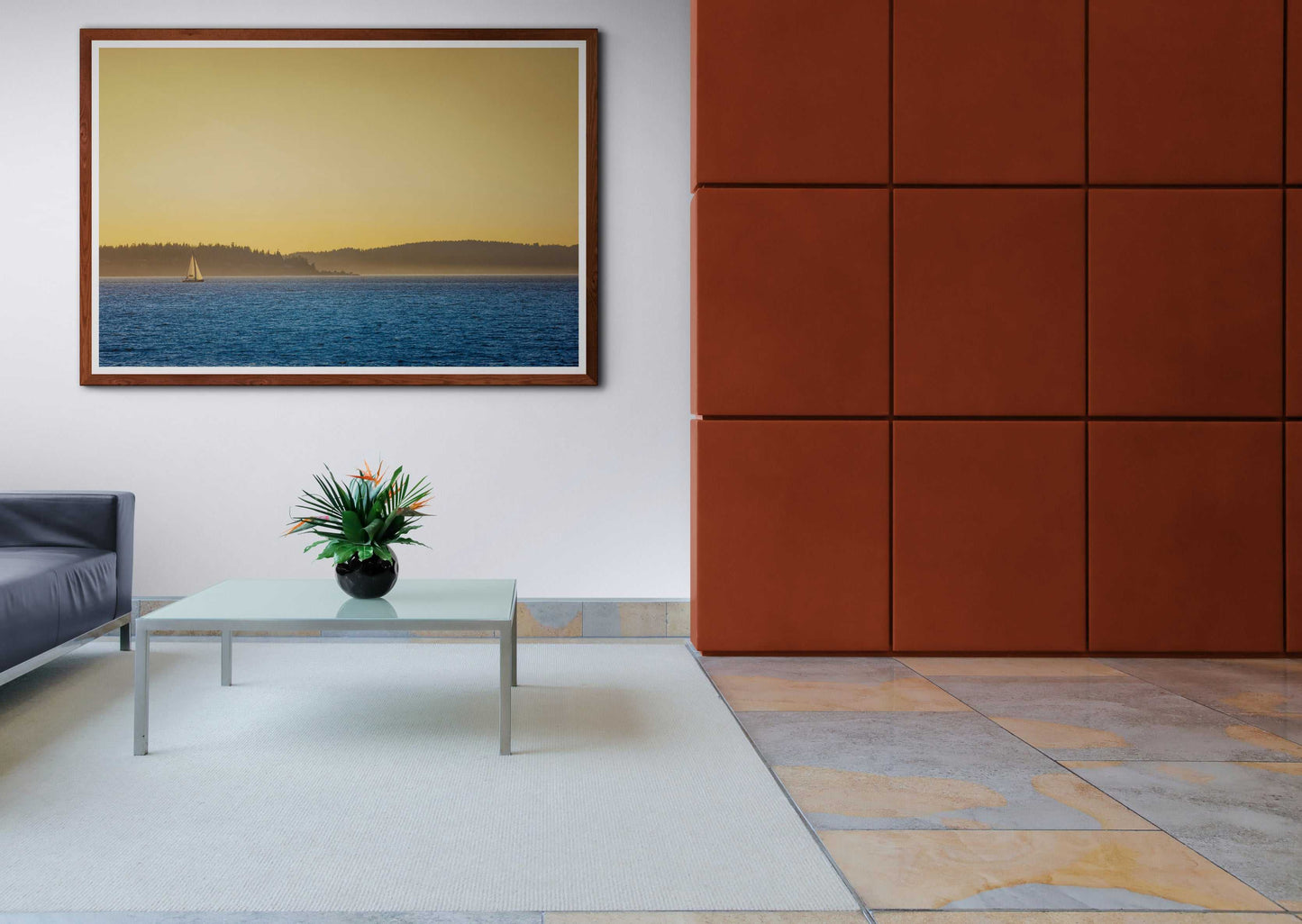 Golden Hour Sailboat limited edition print in a contemporary living room, featuring sunset over Puget Sound with a backlit sailboat.
