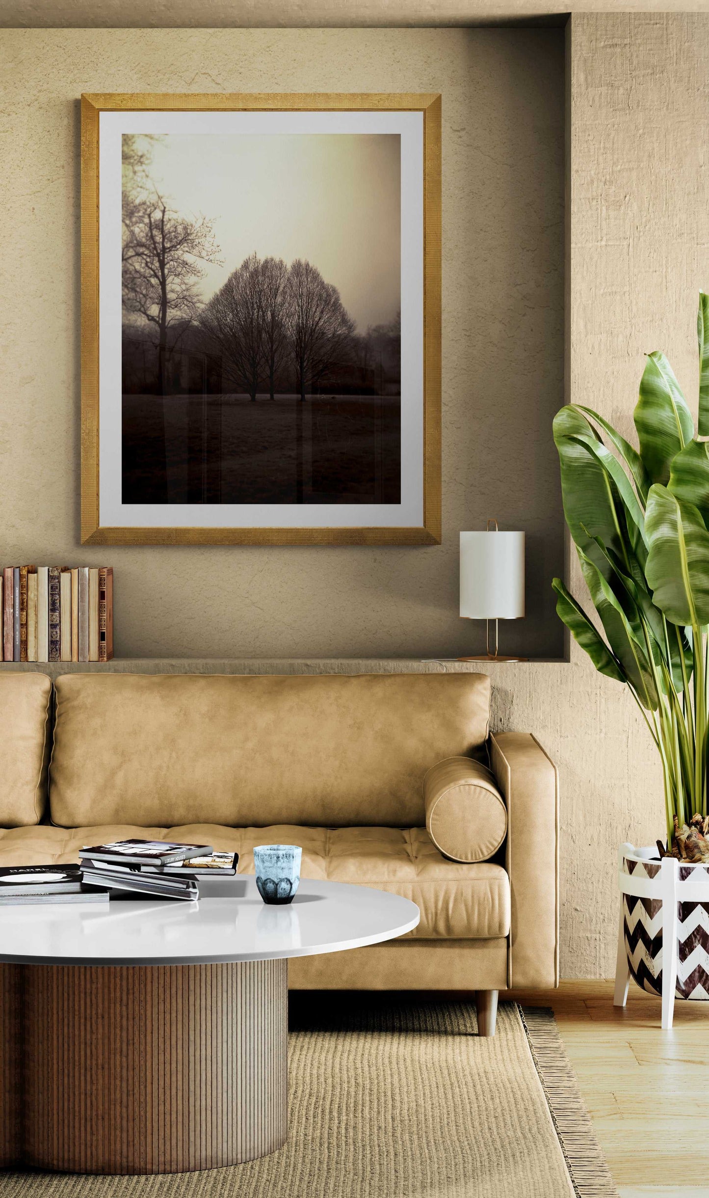 Hyde Park Meadow – Trees and Figures | Holga Film Print from London framed in gold, styled above a tan leather sofa in a modern living room decor.