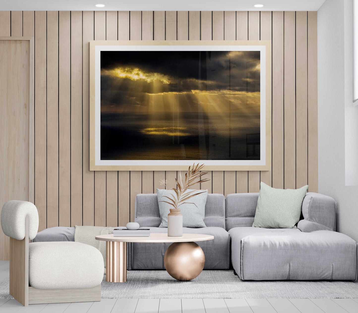 Ring of Light sunrise fine art print displayed in a modern living room with neutral tones and wood paneling, enhancing serene coastal decor.