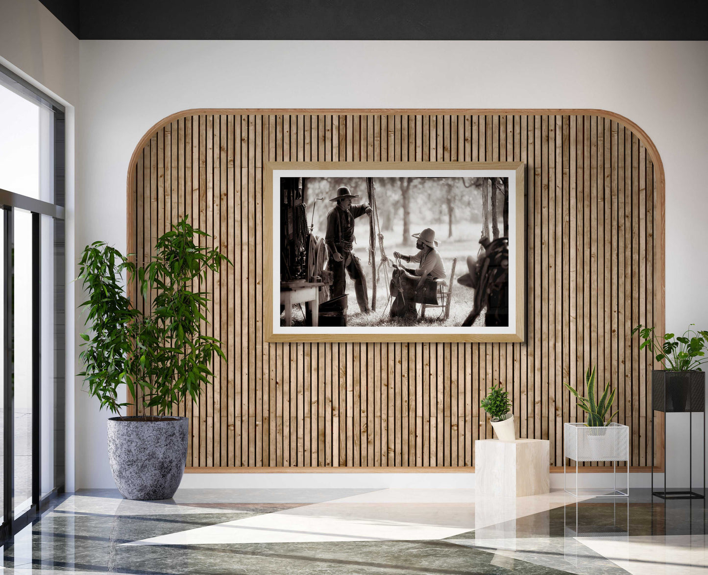 Vintage chuckwagon cowboy scene 'Camp Talk: A Chuckwagon Cook-Off in Authentic Old West Style' displayed in a rustic-modern lobby with wood paneling and indoor plants.