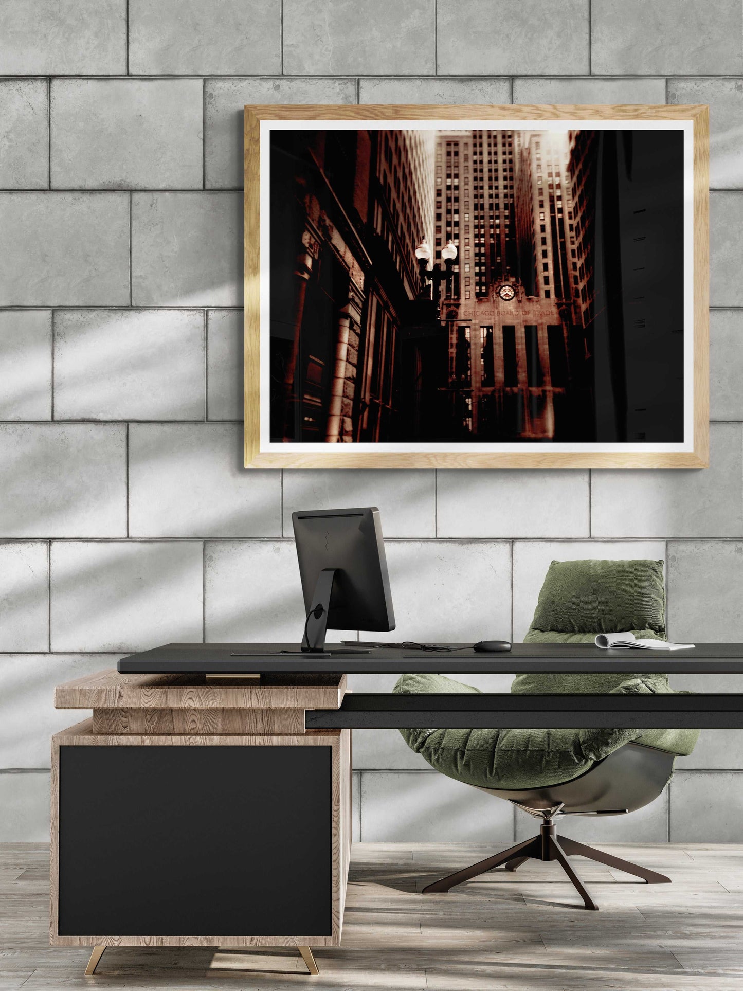 Limited edition Chicago Board of Trade sepia photo framed in gold, displayed above a modern desk in a concrete wall office setting.