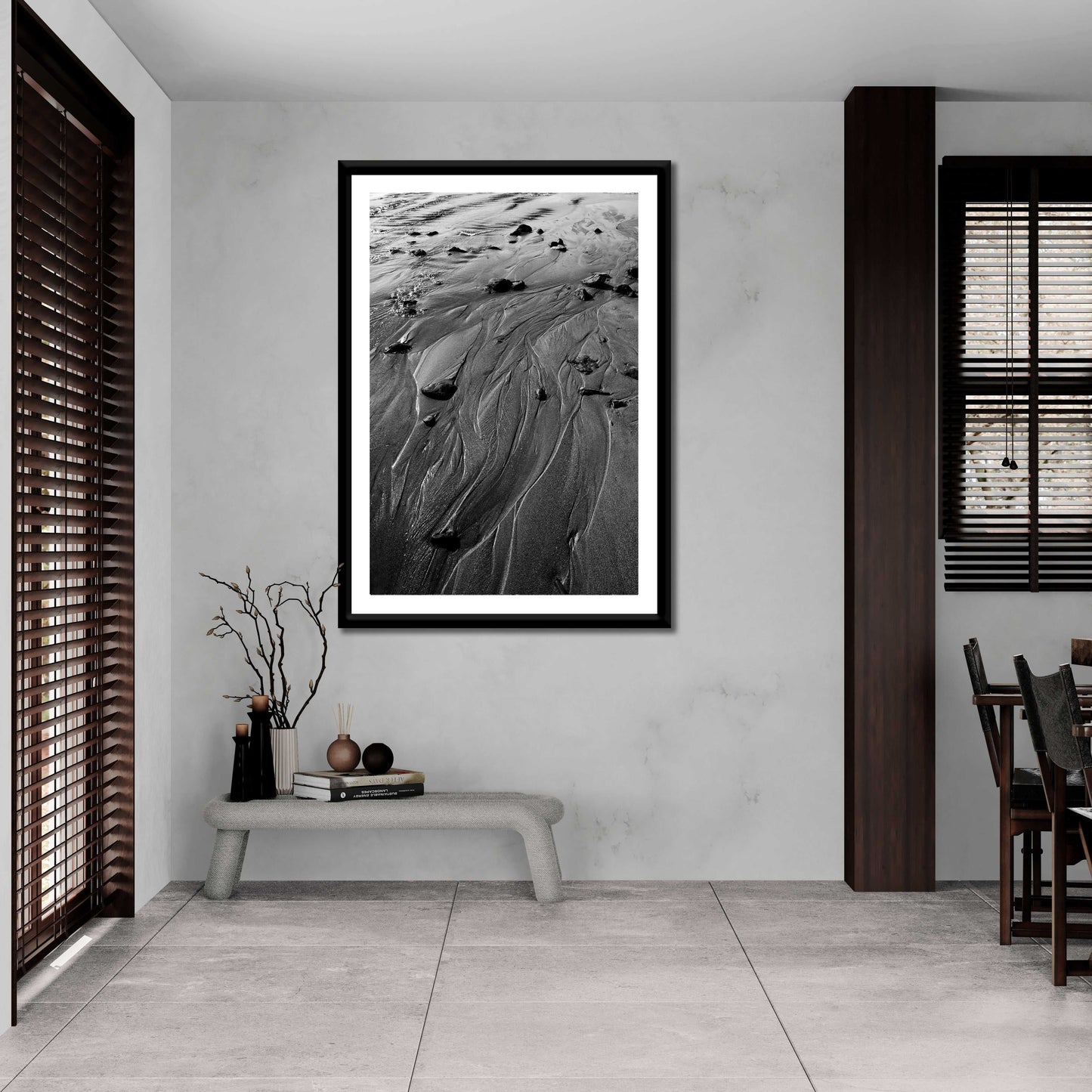 Framed 'Traces #3' black and white sand photography enhances a contemporary dining space with natural coastal textures and fine art appeal.