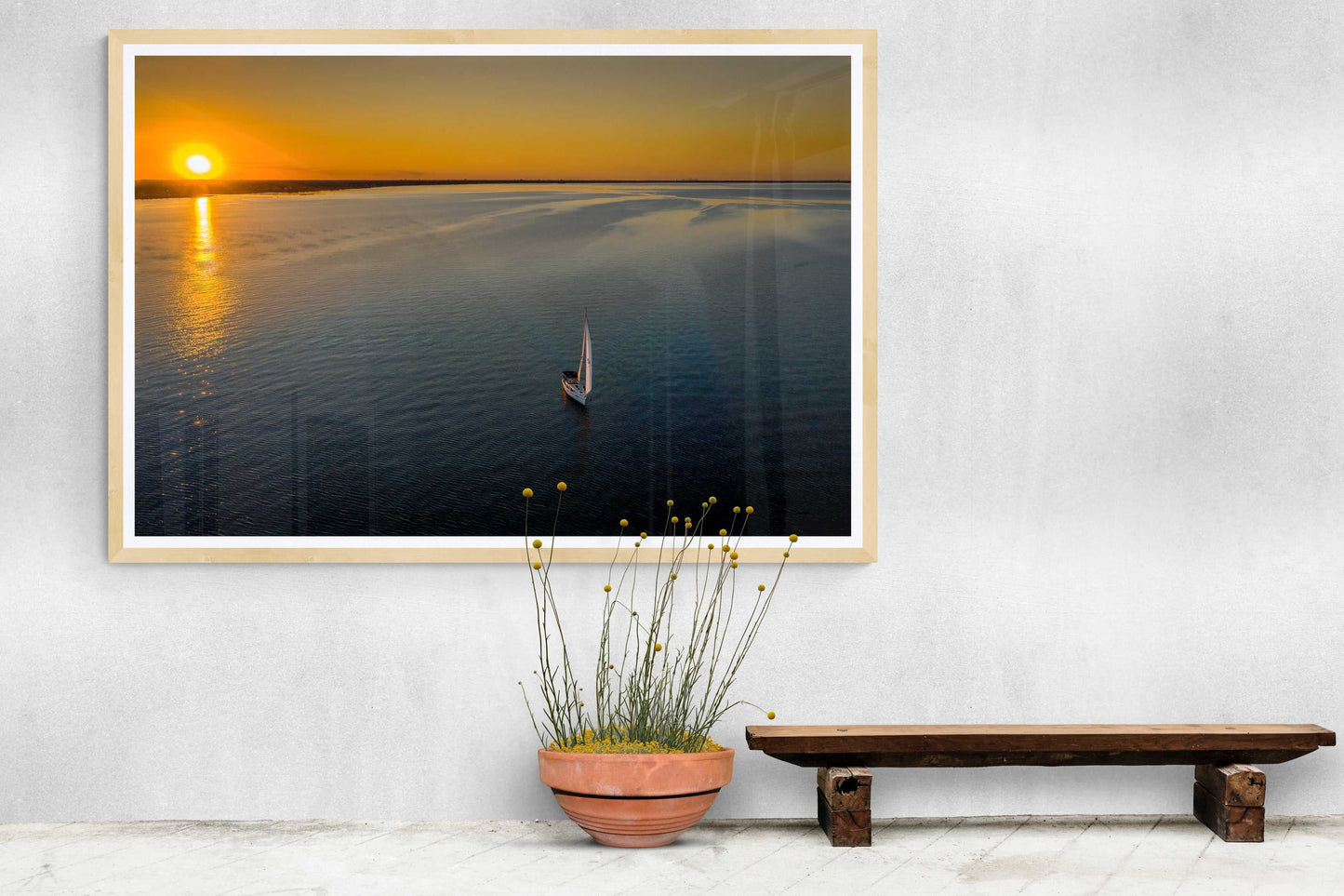 Sunset Sail – Fine Art Aerial Photograph Over Galveston Bay in a minimalist hallway. Framed seascape print adds warmth to modern decor.