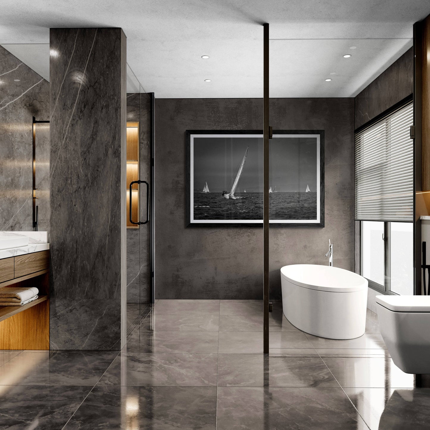 Framed black and white sailing photograph on the wall of a modern bathroom with a freestanding bathtub, and marble walls.
