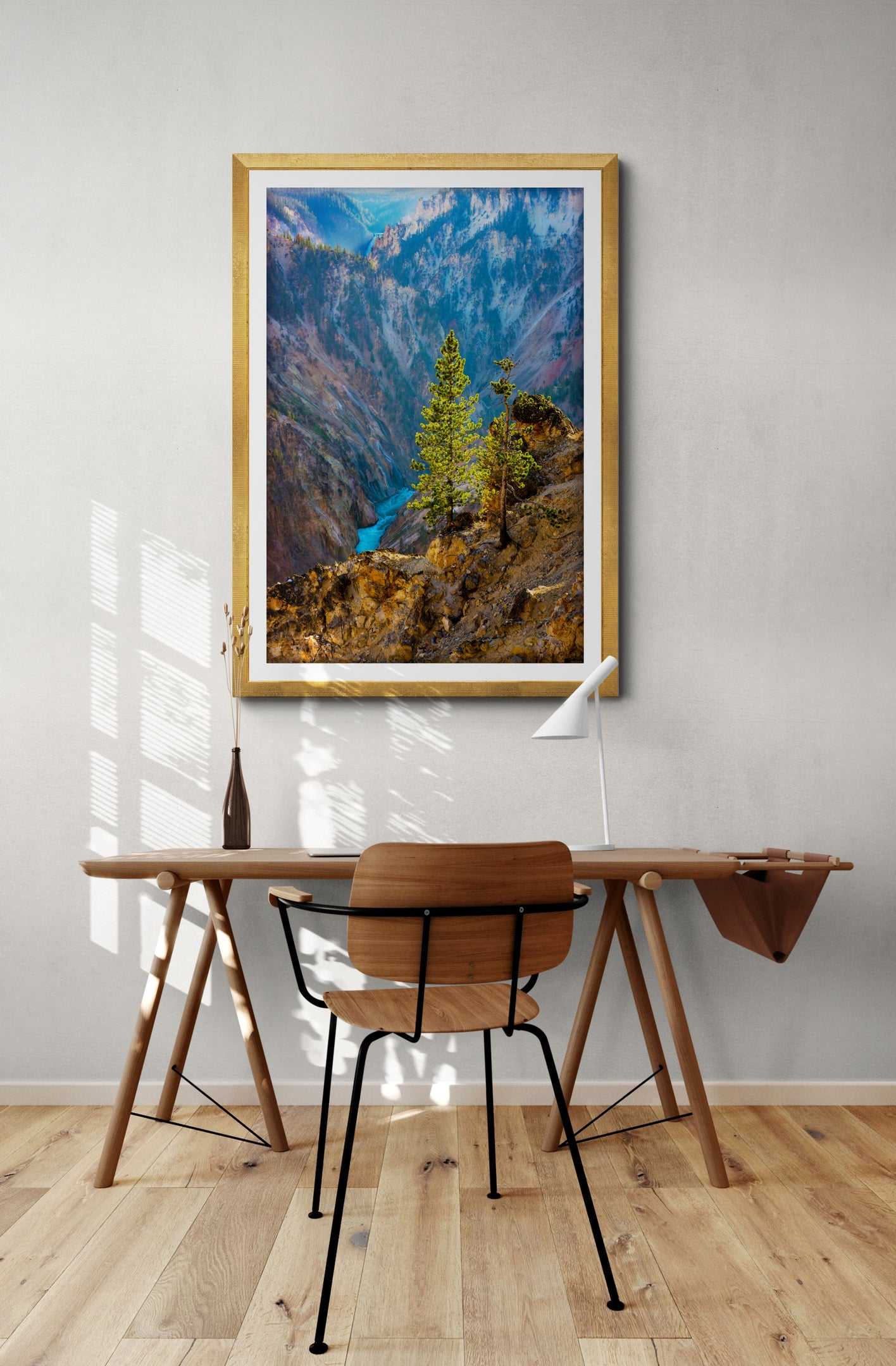 Framed Yellowstone River fine art print with lone tree decorates a modern home office. Limited edition landscape artwork for nature lovers.