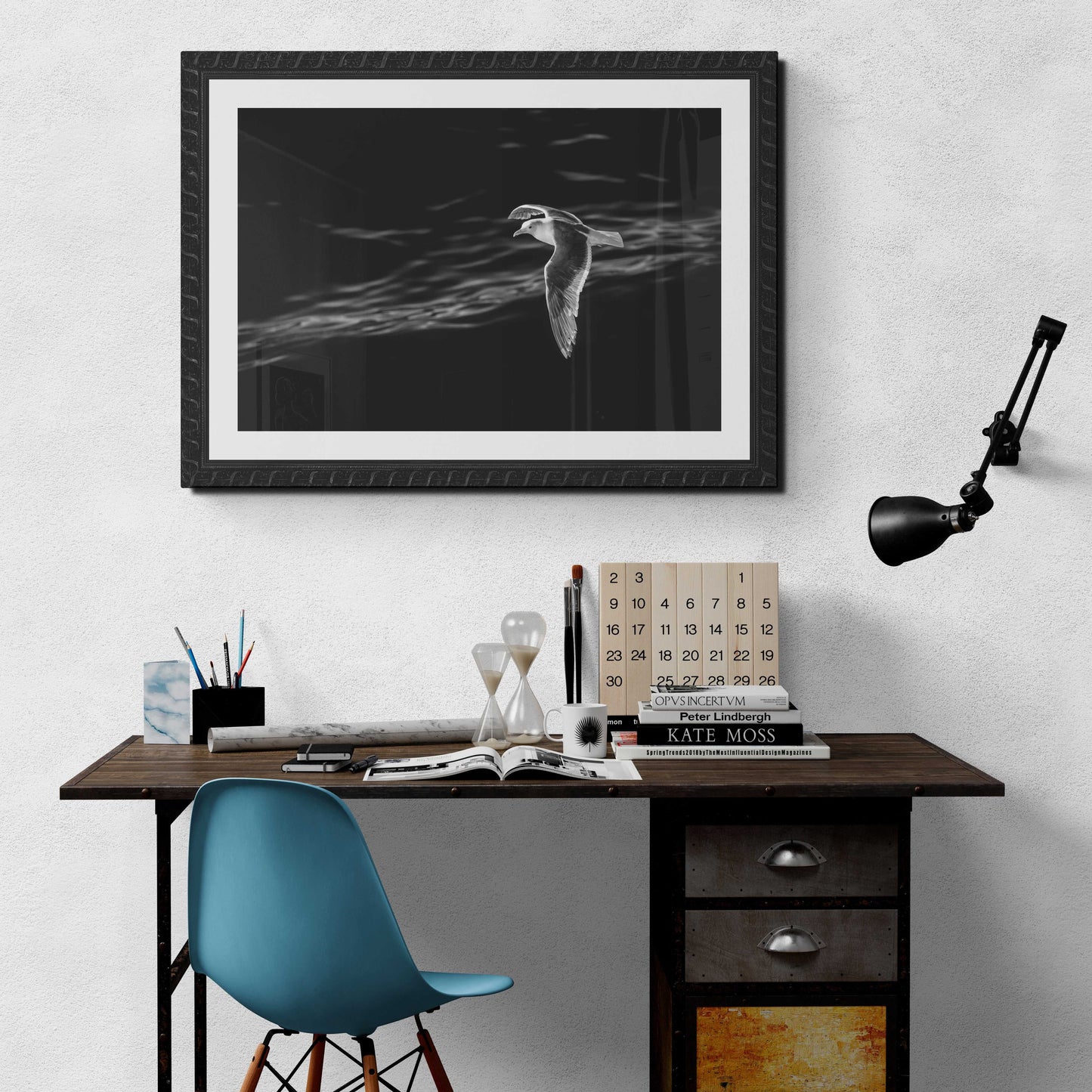 Graceful Flight – A Seagull Over Puget Sound in Black & White wall art featured above a rustic desk, perfect for serene workspace inspiration.