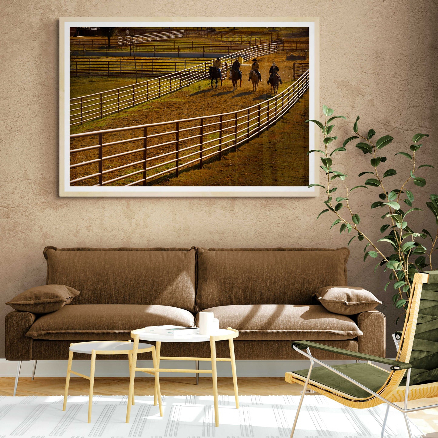 Cowboy Quartet: Morning Light and Motion at the Corral cowboy wall art framed above a brown sofa in a cozy, rustic living room setting.