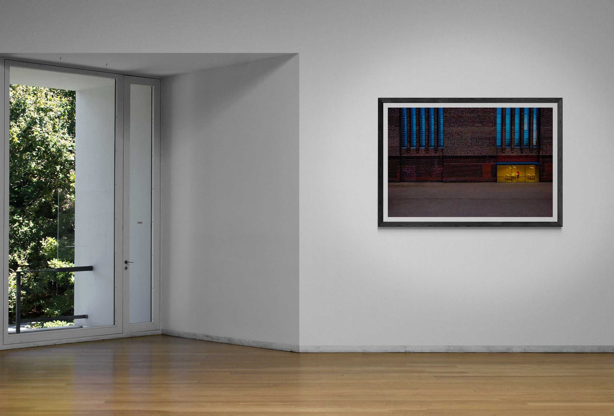 The Tate Modern – A Study in Color and Line fine art print mounted in a bright gallery space with natural light, emphasizing its architectural and color contrasts.
