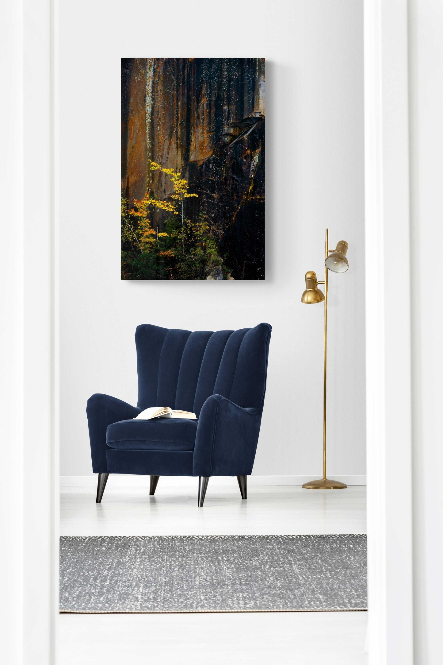 Unframed Quarry Wall #2 print mounted in a bright hallway with navy chair. Vertical Nature Photography adds texture and fall color to interiors.