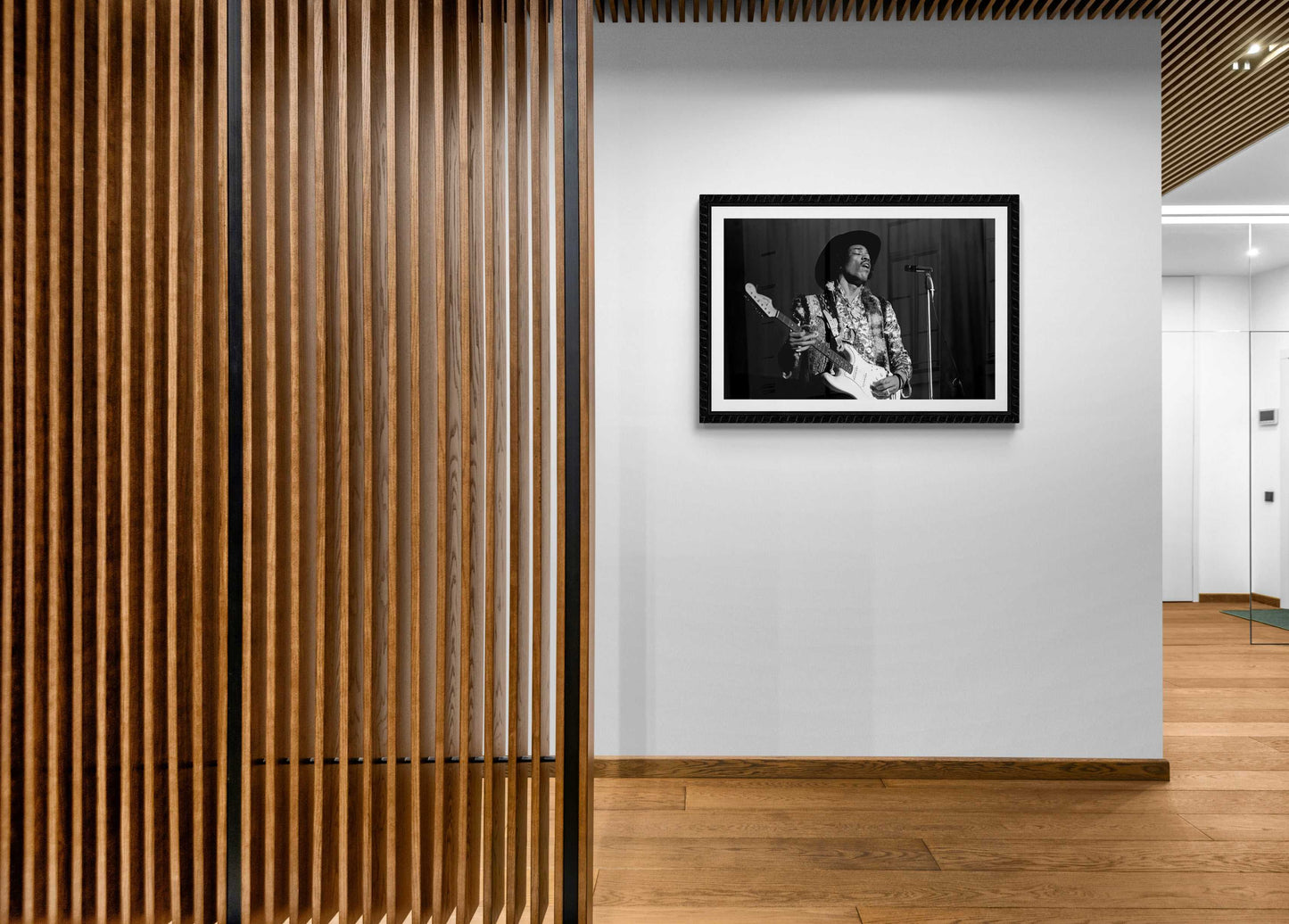 Modern hallway featuring framed Jimi Hendrix black and white photo, adding a touch of rock legend artistry to contemporary decor.