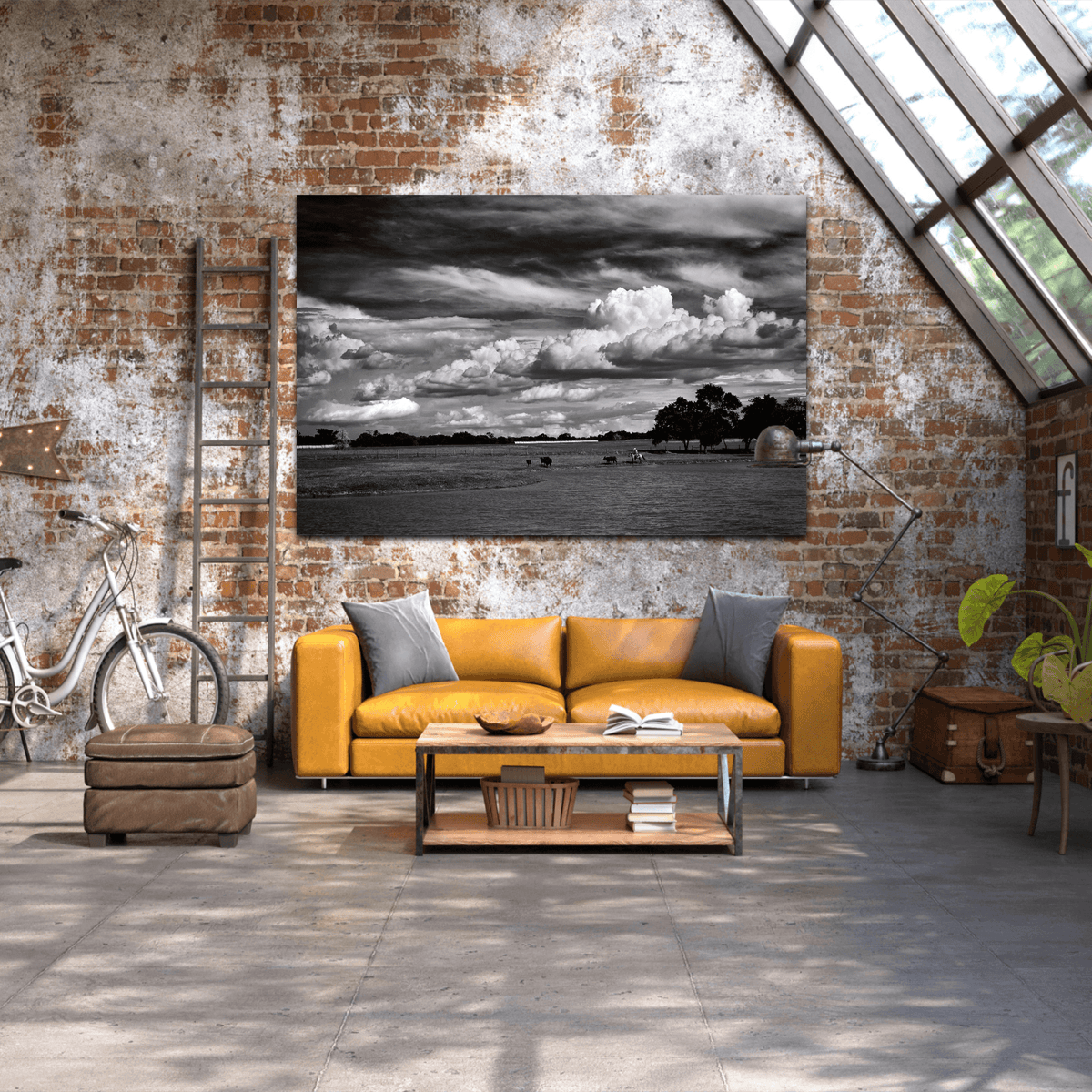 Large black and white cowboy print 'Under a Texas Sky' mounted above a yellow leather sofa in an industrial loft with rustic decor.