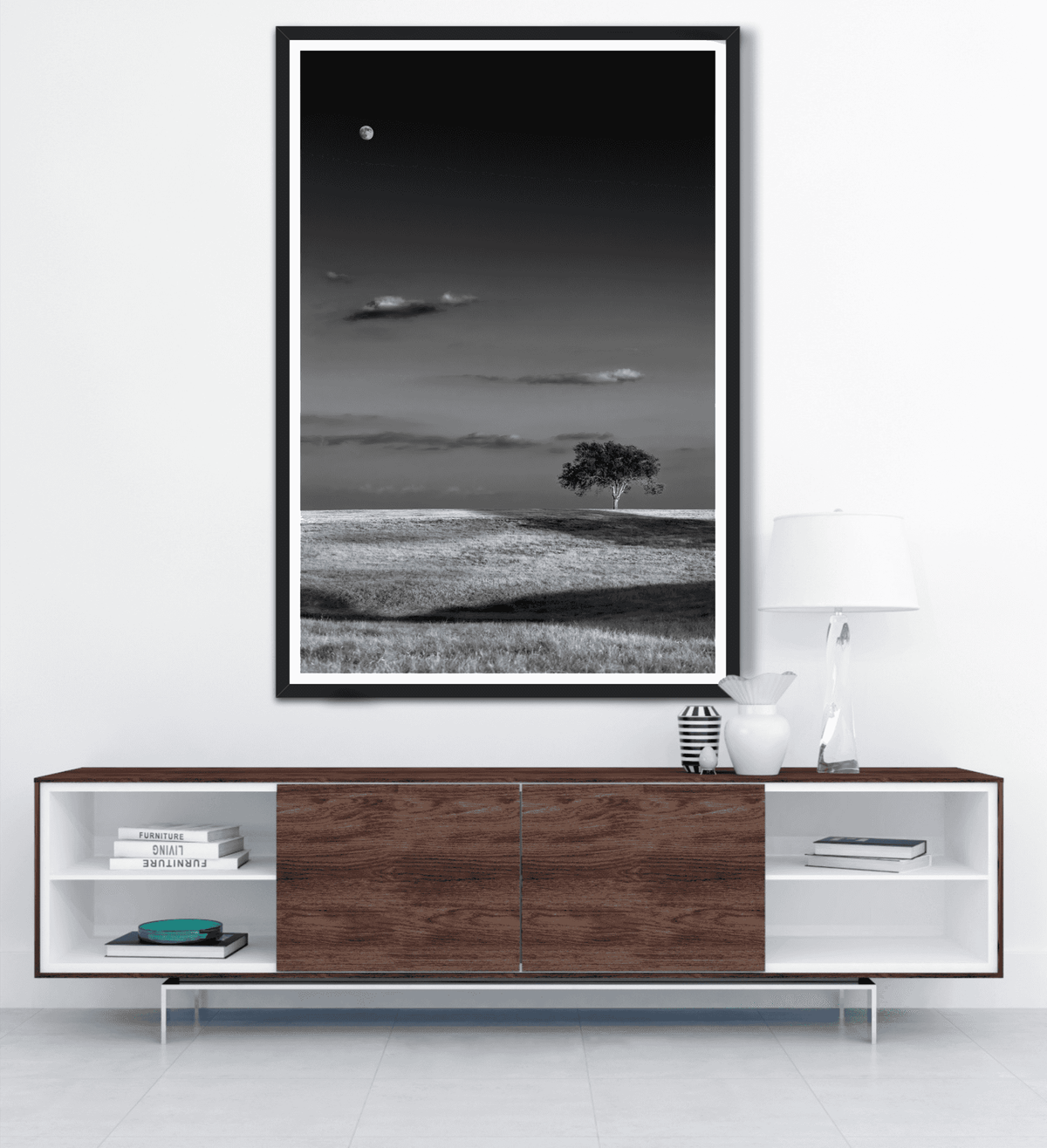 Large framed Moonrise at Sunset – Black and White Texas Fine Art Print by Michael Hart hanging above a sleek wood and white media console.