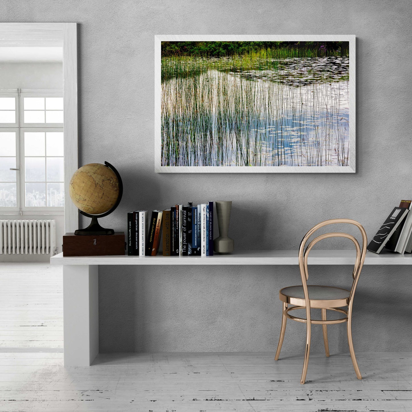 Lochinver Reflections fine art print displayed above a modern white desk, enhancing minimalist home office decor with Scotland landscape photography.