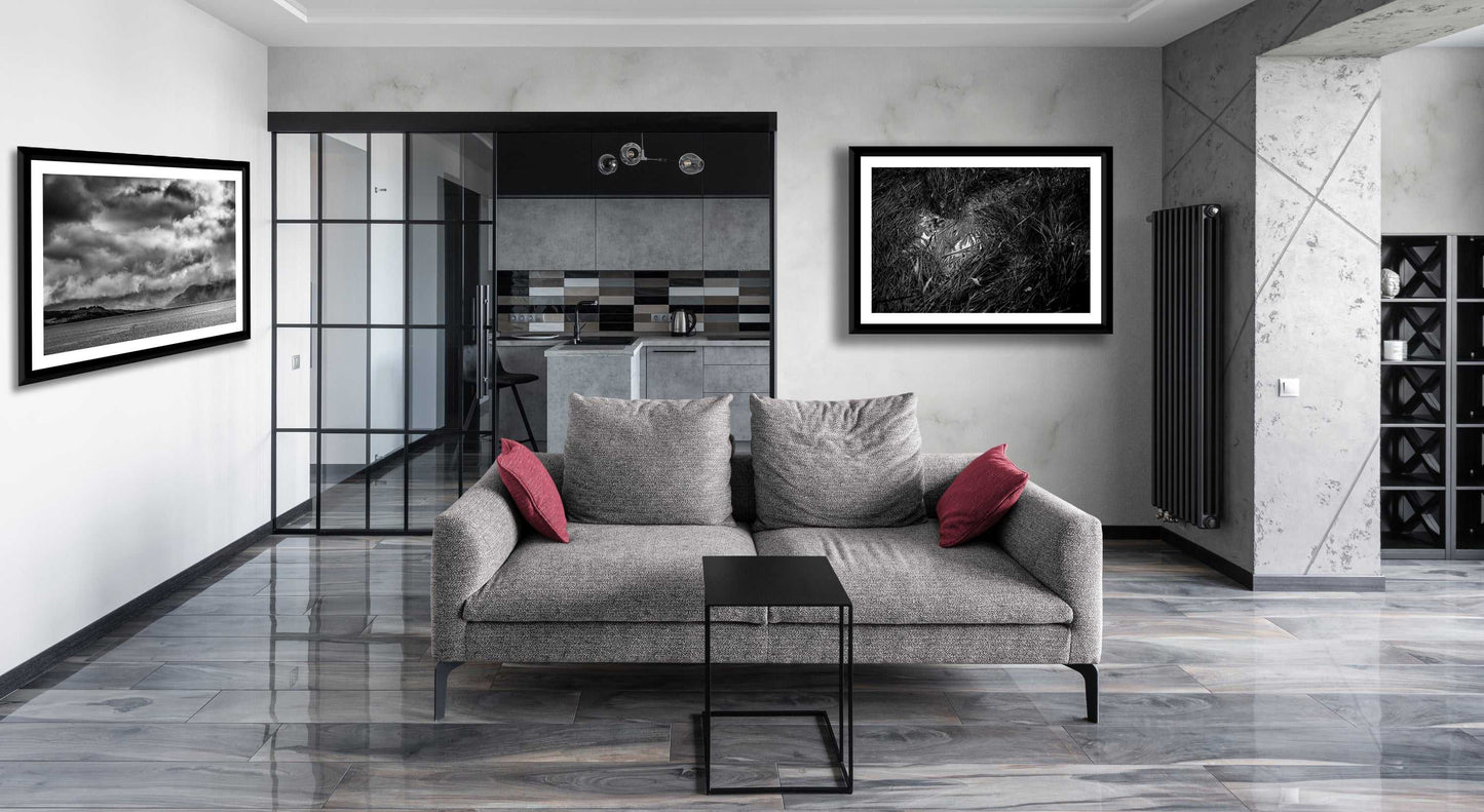 Archival print of Storm Clouds rolling ij to Kyleakin, Isle of Skye,  displayed in a modern grey living room. A bold monochrome landscape adds depth to interior decor.