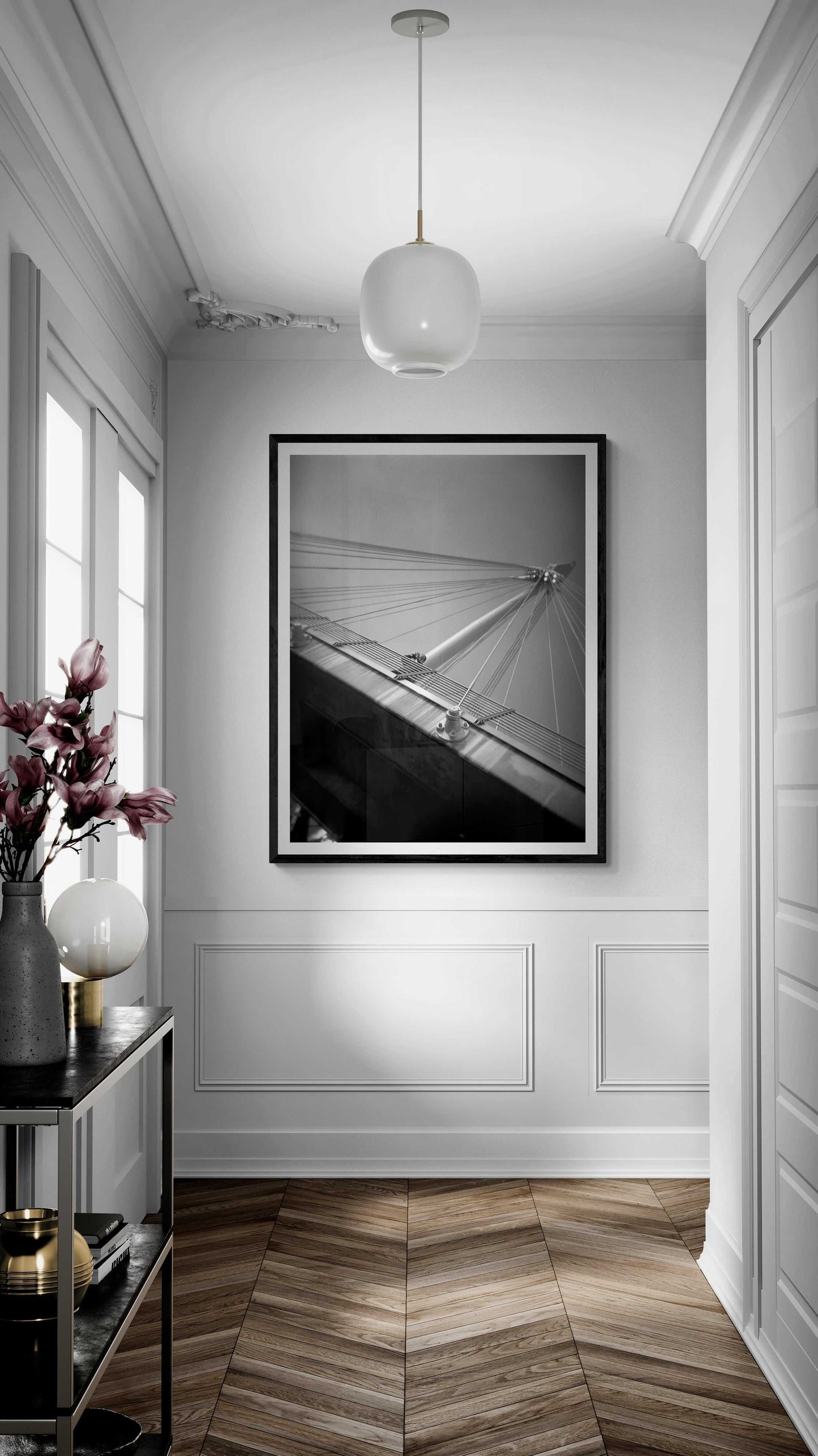 A framed black and white Holga camera image of the Golden Jubilee Bridge in London, England in an upscale home hallway