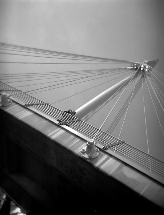 A black and white Holga camera image of the Golden Jubilee Bridge in London, England