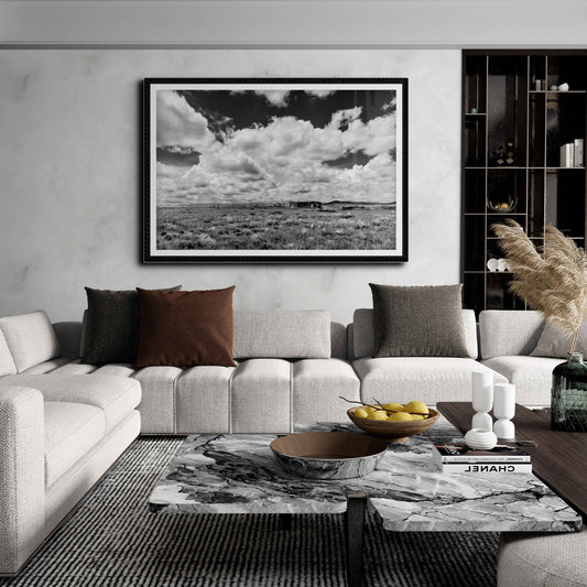 Abandoned New Mexico – Limited Edition Black and White Fine Art Photograph displayed in a modern living room. Dramatic sky and ranch ruins evoke solitude.