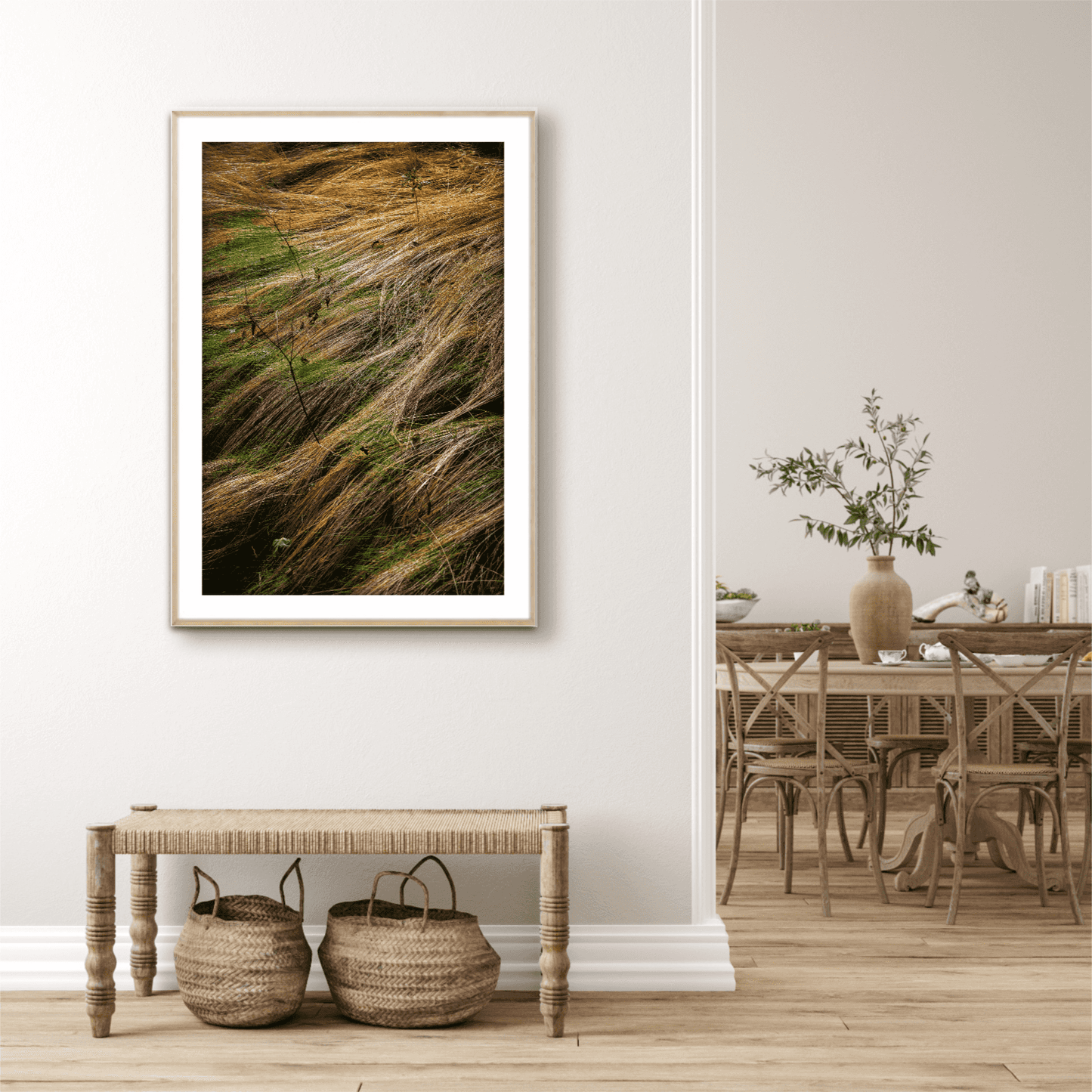 “Autumn Grasses #2, Acadia” – A limited edition fine art photograph of golden wild grasses in motion, displayed in a modern home interior. Vertical wall art ideal for nature-inspired decor.