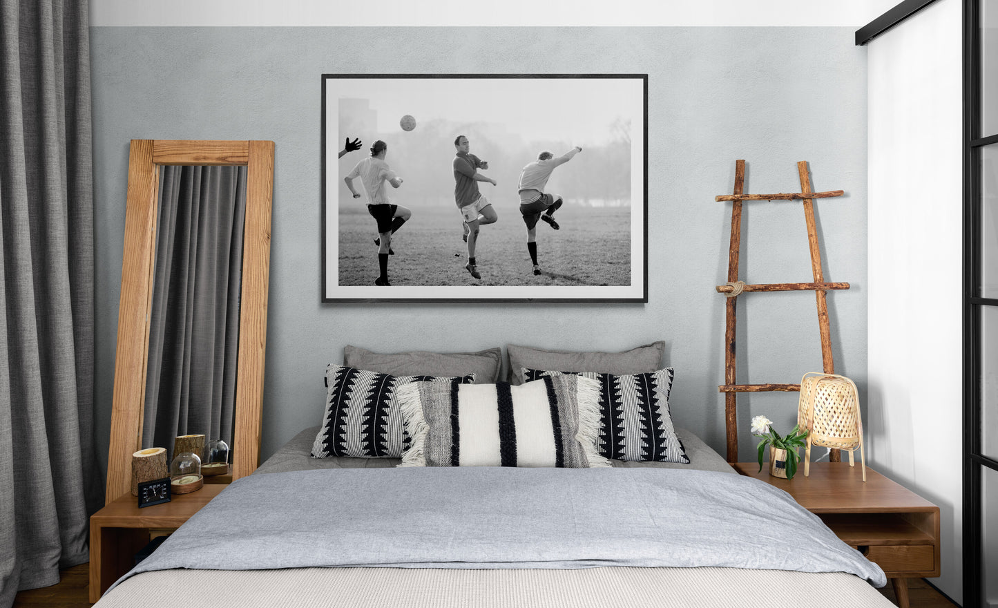 Black and white street photography print of three men playing football in Hyde Park, London