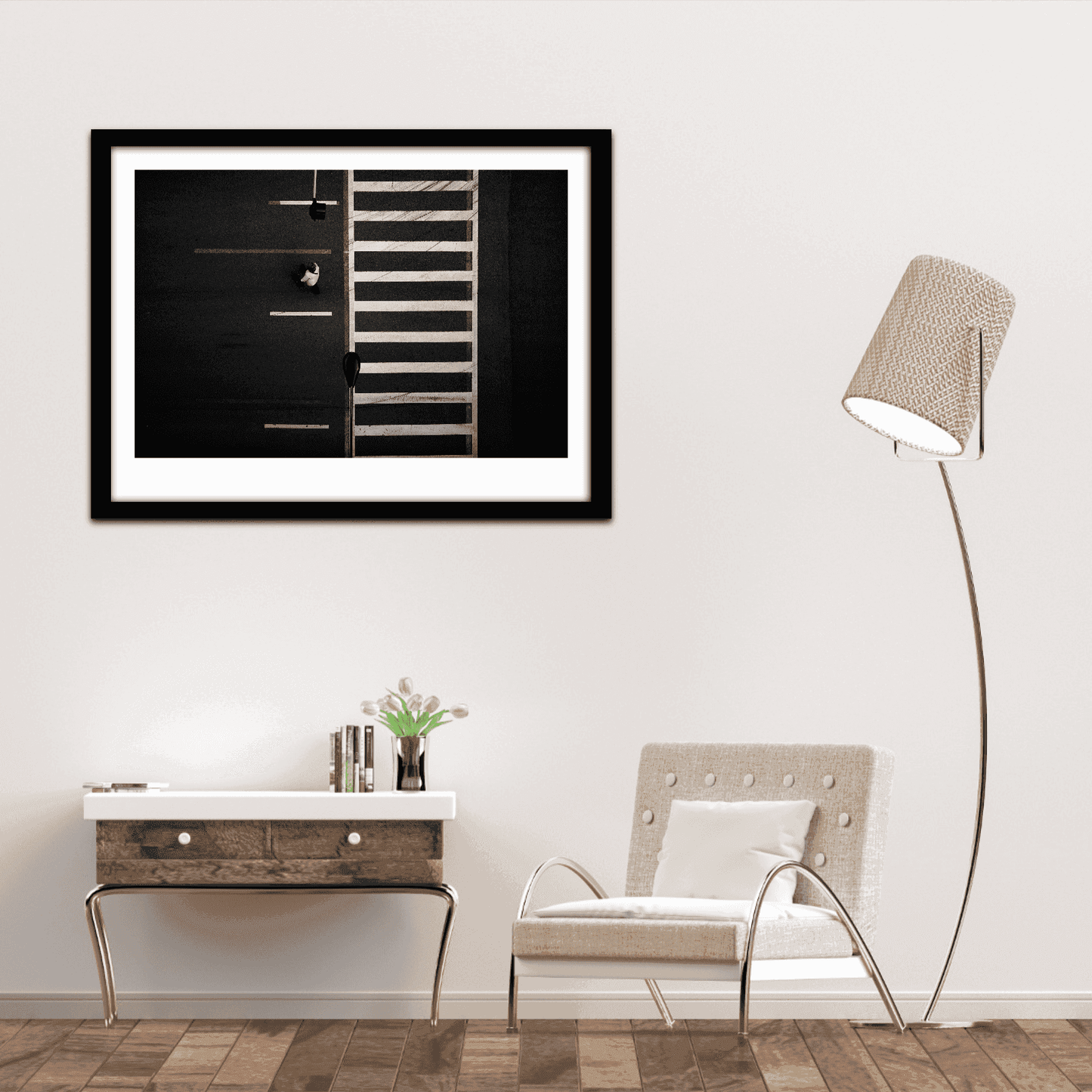 Framed image of overhead black and white photograph of Chicago crosswalk with pedestrian and graphic street pattern on wall of seating area in contemporary home.