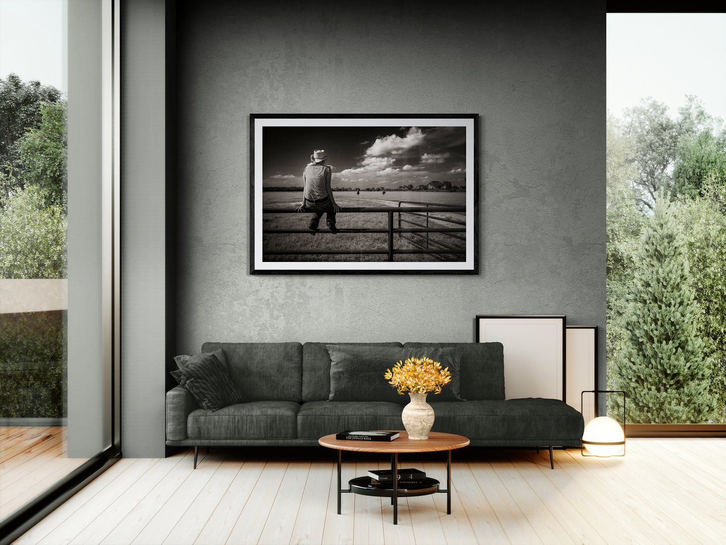 Framed fine art print of Coming Home, a woman on a. ranch fence, on the wall of an airy contemporary house.
