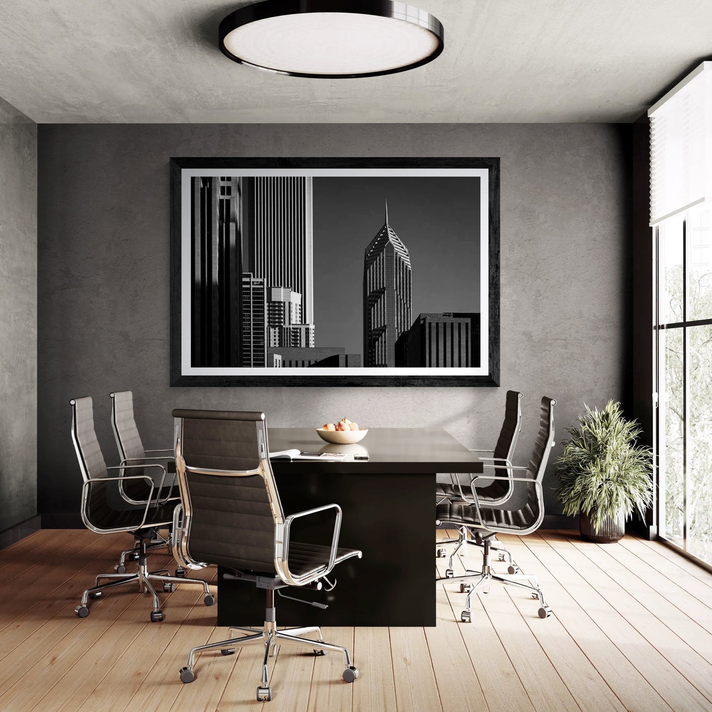 Modern conference room with black leather chairs around a dark wood table, large window with blinds, and a black and white cityscape artwork on textured gray wall
