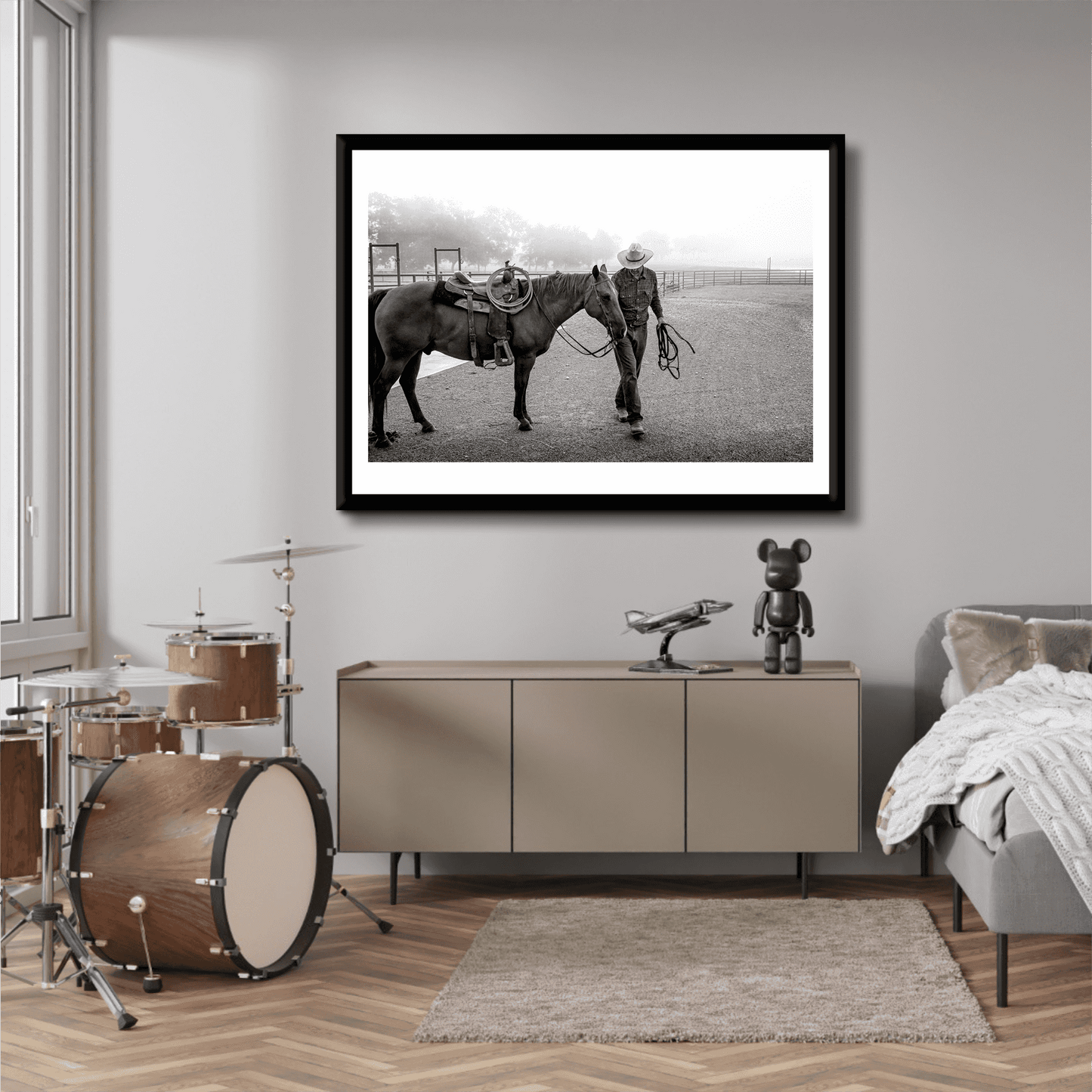 Morning Ride – Saddling Up in the Fog, Black and White Ranch Print by Michael Hart displayed in a modern bedroom above a console. Limited edition Texas ranch wall art.
