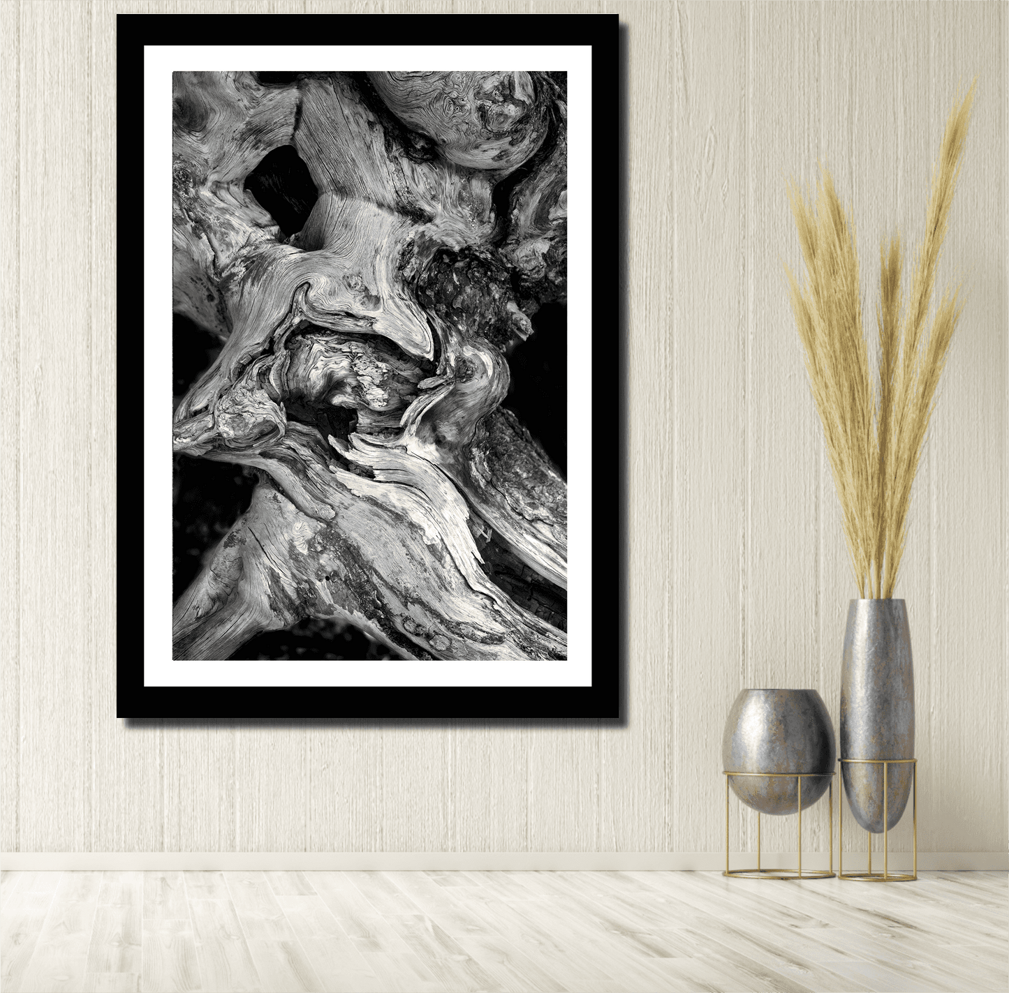 Dead Tree Detail, Yellowstone – Limited Edition Black and White Fine Art Photograph in black frame, styled in a neutral-toned room with tall vases and textured wall.