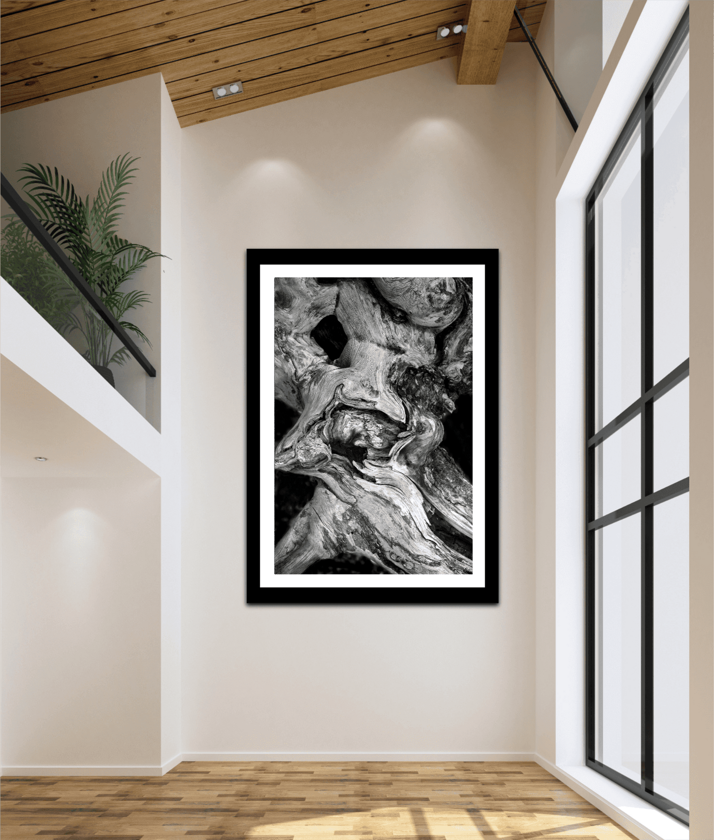 Dead Tree Detail, Yellowstone – Limited Edition Black and White Fine Art Photograph in a large black frame, showcased in a bright, modern loft with high ceilings.