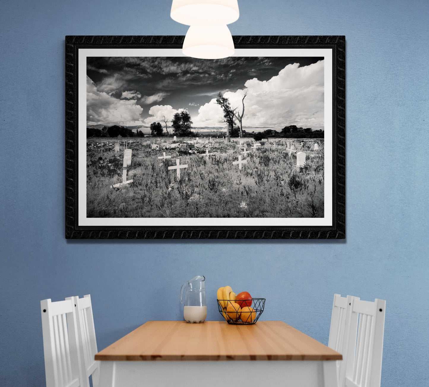 Framed Fort Washakie Cemetery black and white print in cozy kitchen nook, bringing historical landscape art into everyday home settings.