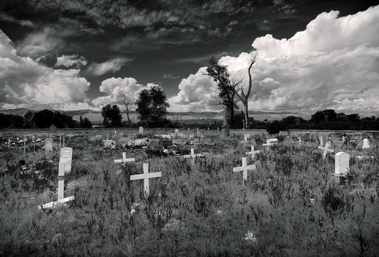 Fort Washakie Cemetery — black and white photograph of burial grounds on the Wind River Reservation in Wyoming beneath expansive clouds, a quiet study of place, history, and landscape