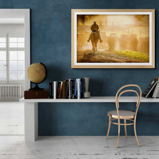 Golden Hour Roundup – Texas Cowboy and Cattle at 44 Farms framed wall art displayed in a modern home office. Western decor for stylish interiors.