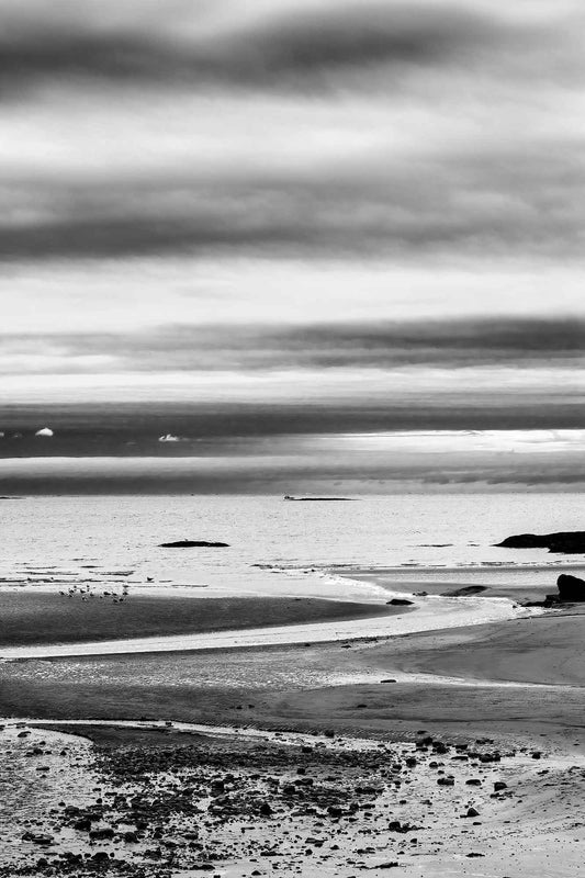 Black and white coastal photograph of tidal patterns and shoreline at Cushing, Maine with layered sky and soft tonal gradients
