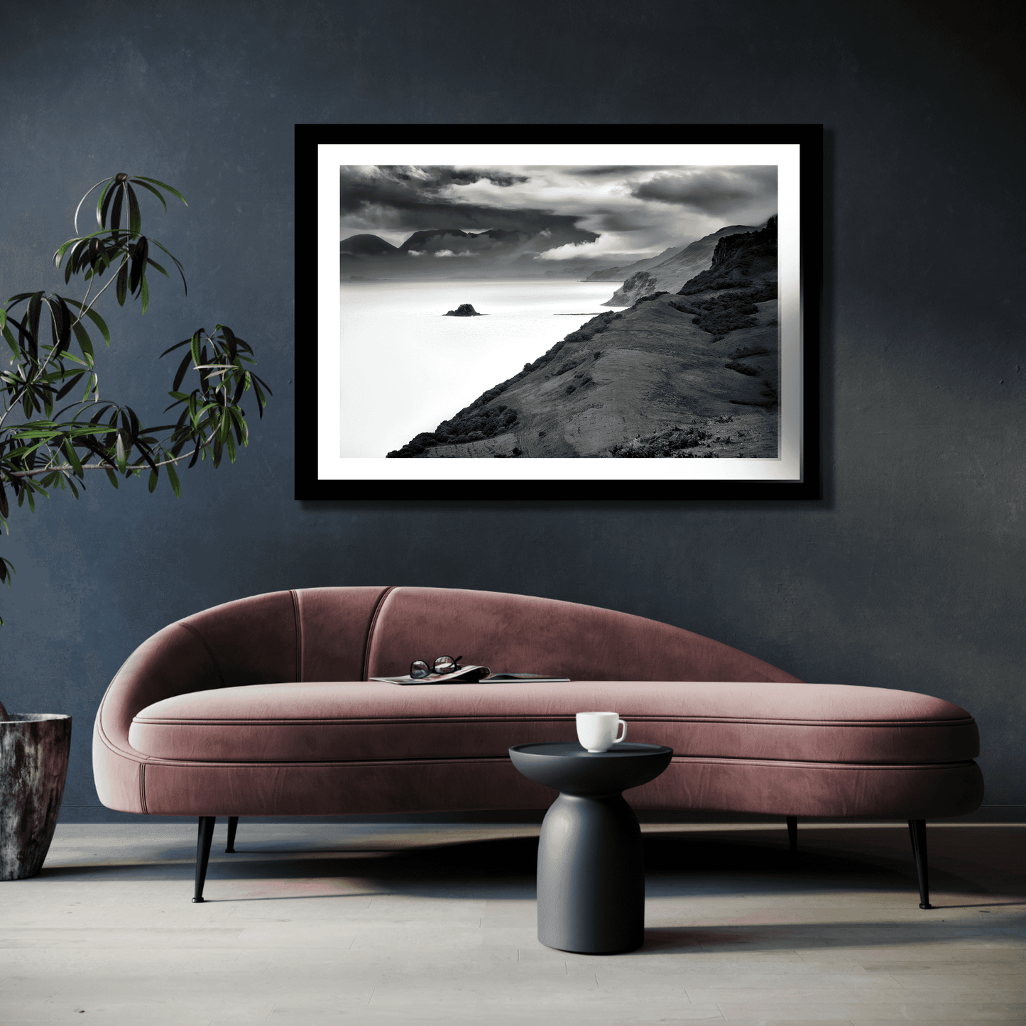 Holm Island – Black & White Fine Art Print above a velvet sofa in a stylish living room, perfect for moody coastal-themed interior decor.