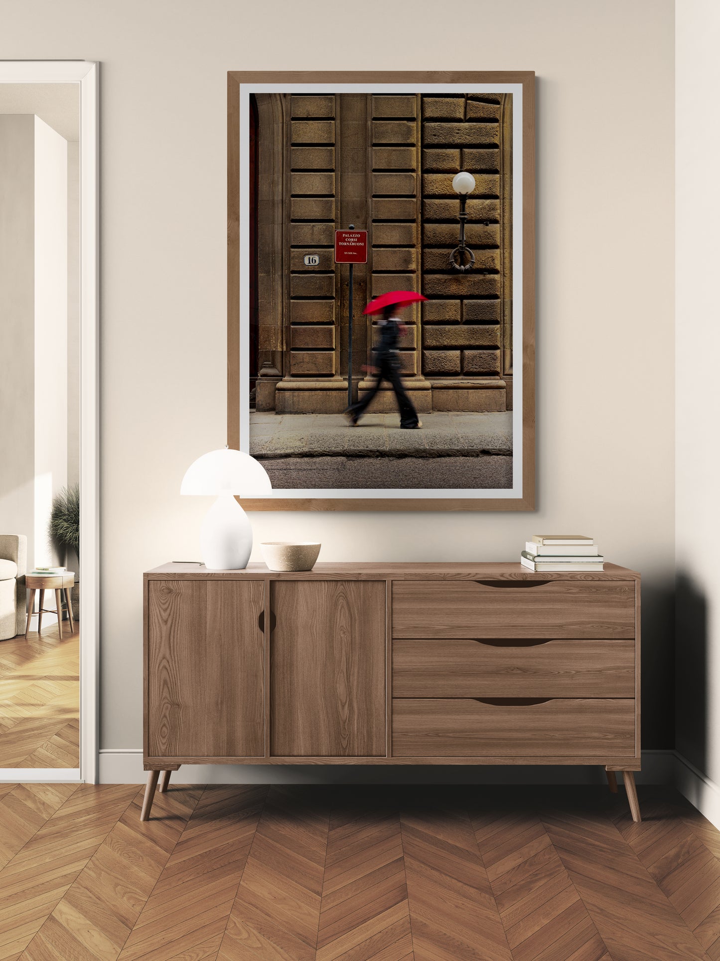 Pedestrian with a red umbrella walking along a rainy street in Zurich, Switzerland.
