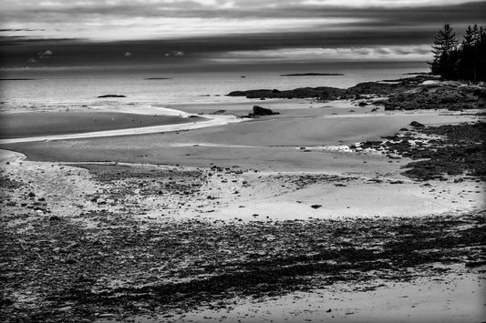 Grey Atlantic #2 – Black and White Coastal Photography in Maine featuring a moody, overcast shoreline with rugged rocks and tidal flats. A fine art seascape print ideal for minimalist and monochrome wall decor.
