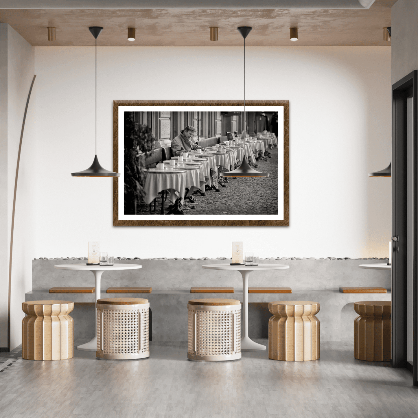 Zurich Series #3 – The Man at the Café, Zurich in Black and White – Fine Art Print by Michael Hart featured in a stylish café interior. A timeless European street scene in black and white perfect for hospitality decor.