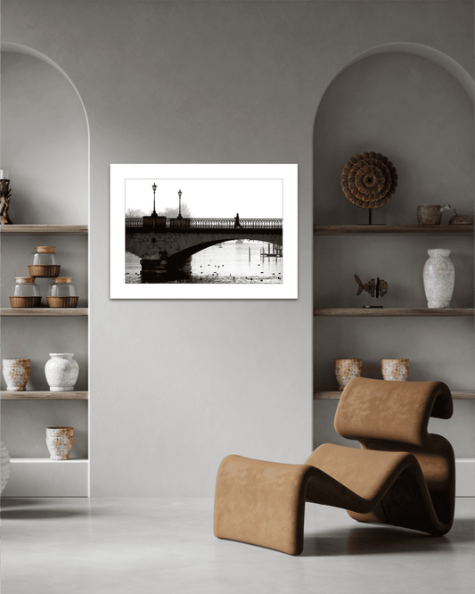 Zurich Series #1 – A Man on the Bridge, Zurich in Black and White – Fine Art Print by Michael Hart displayed in a modern neutral-toned living room with sculptural decor.