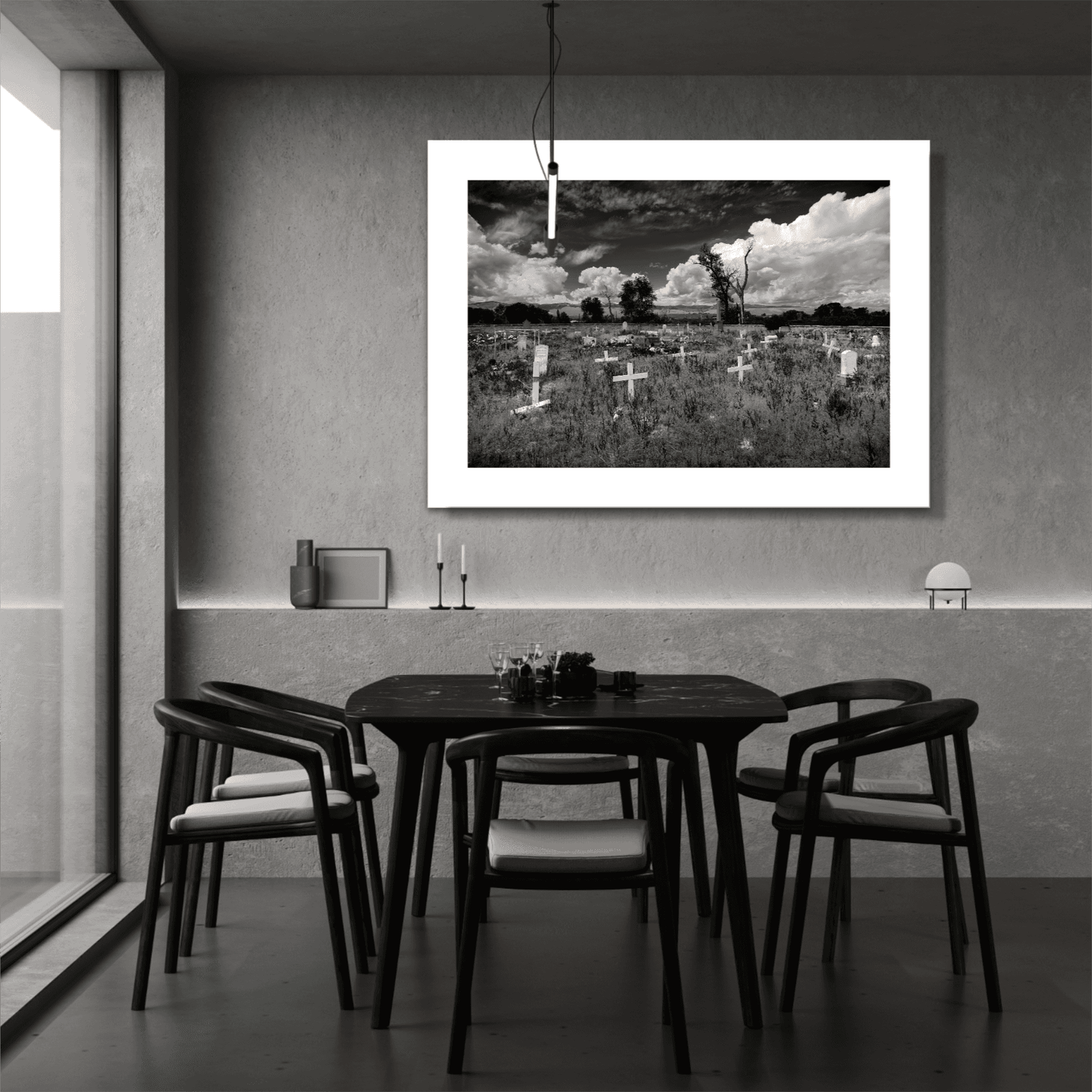 Monochrome Fort Washakie Cemetery print with white mat in modern dining space, emphasizing quiet landscapes and tribal heritage.